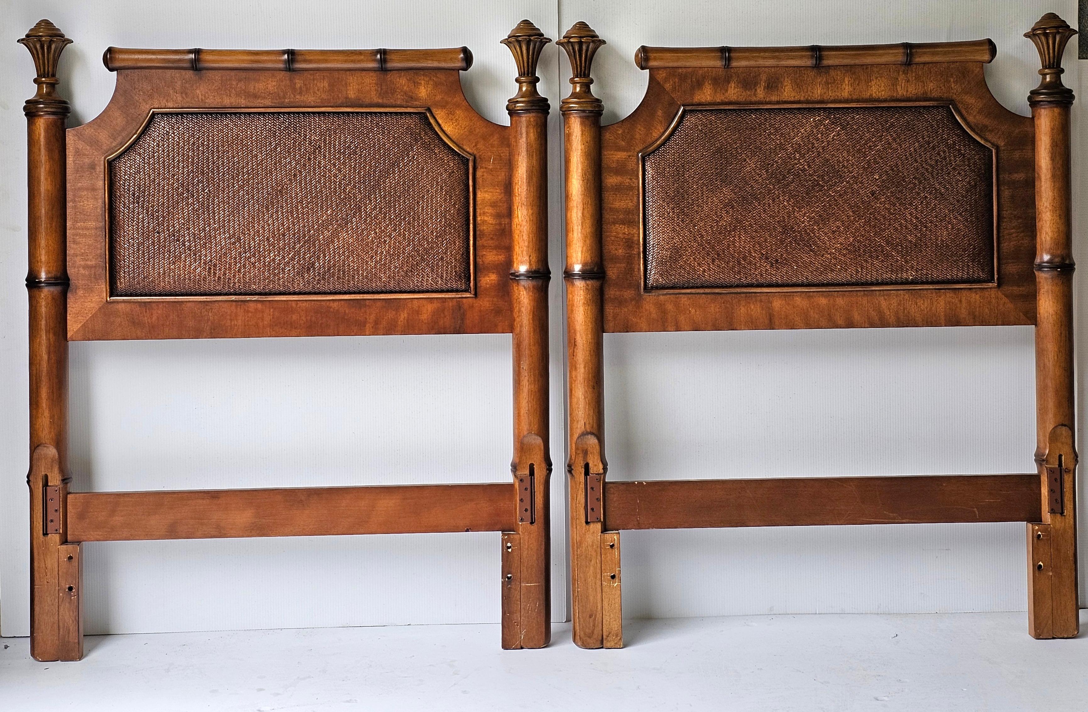 A pair Regency Style twin size Faux Bamboo Walnut And Cane Headboards. They are made of Faux bamboo walnut with a caned panel in the center. The style is reminiscent of the Regency era with some French Country detailing. They are very solid and