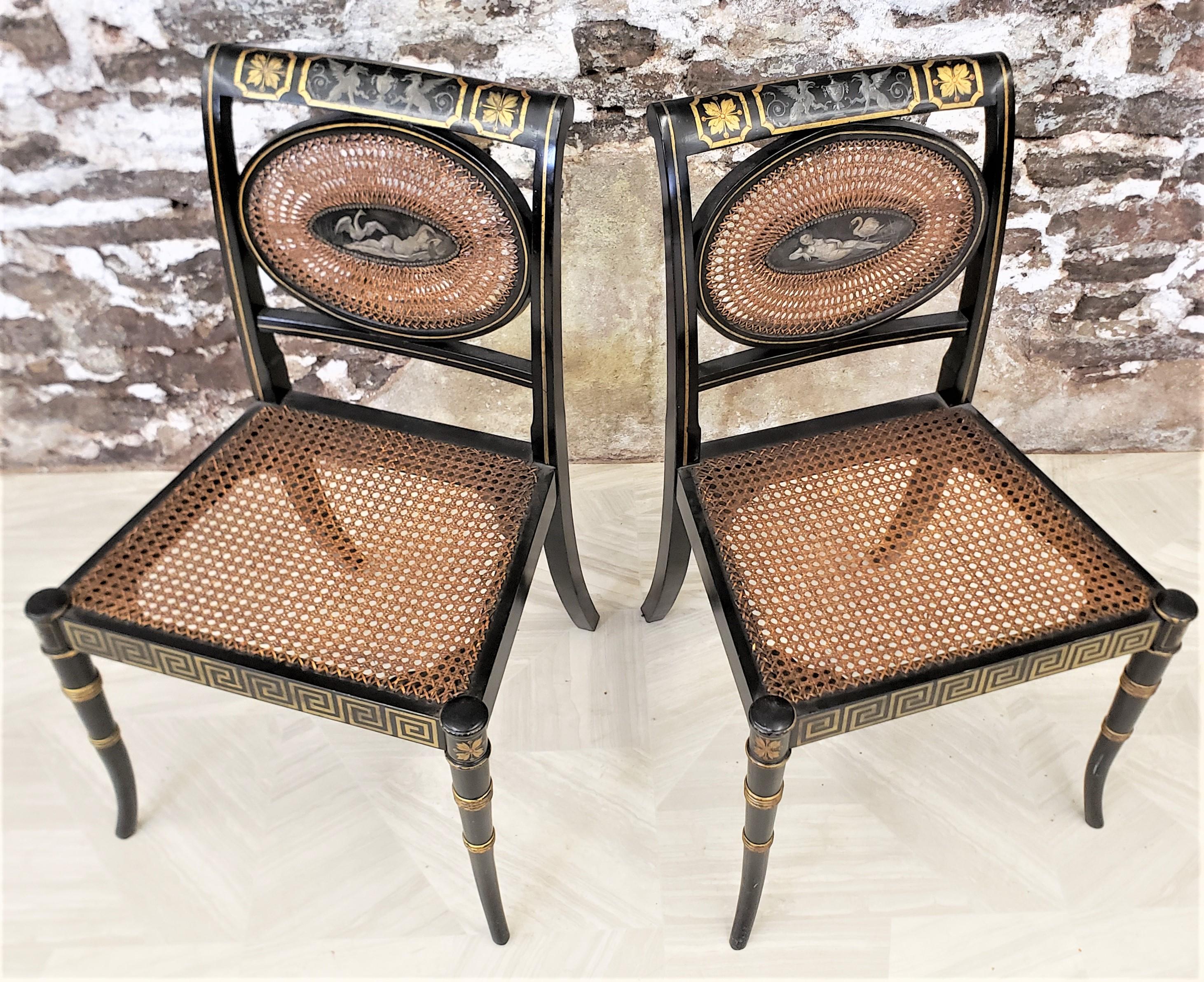 This pair of antique chairs are unsigned, but presumed to have originated from the United States and date to approximately 1920 and done in a Regency, or Hollywood Regency style. The chairs are done with pine frames with an ebonized finish with gilt