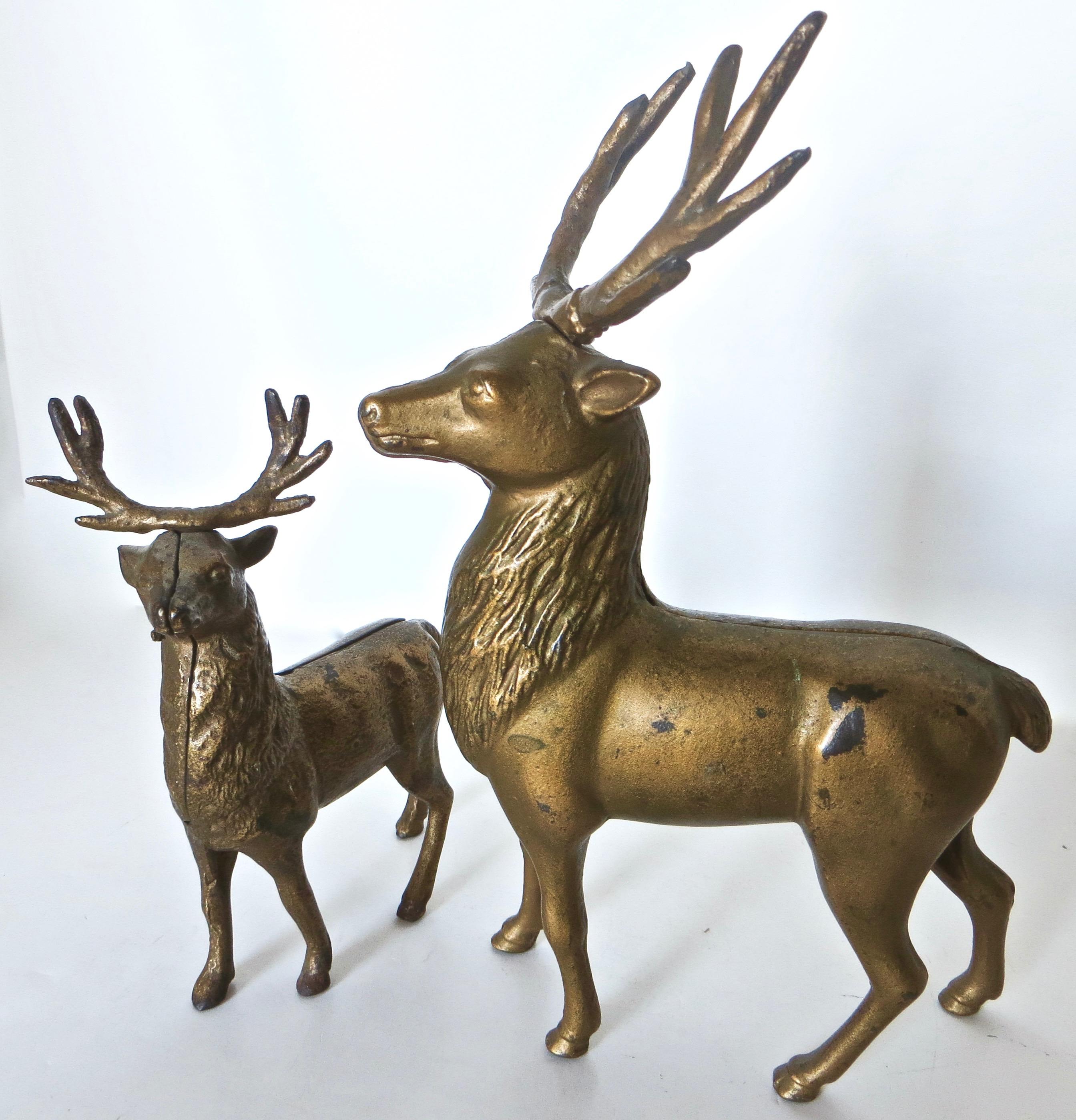 These two authentic cast iron antique still banks depict a large reindeer and a smaller one standing nearby. Together, they make a wonderful Christmas or holiday winter display. They are both of American manufacture and were made circa 1910 by the