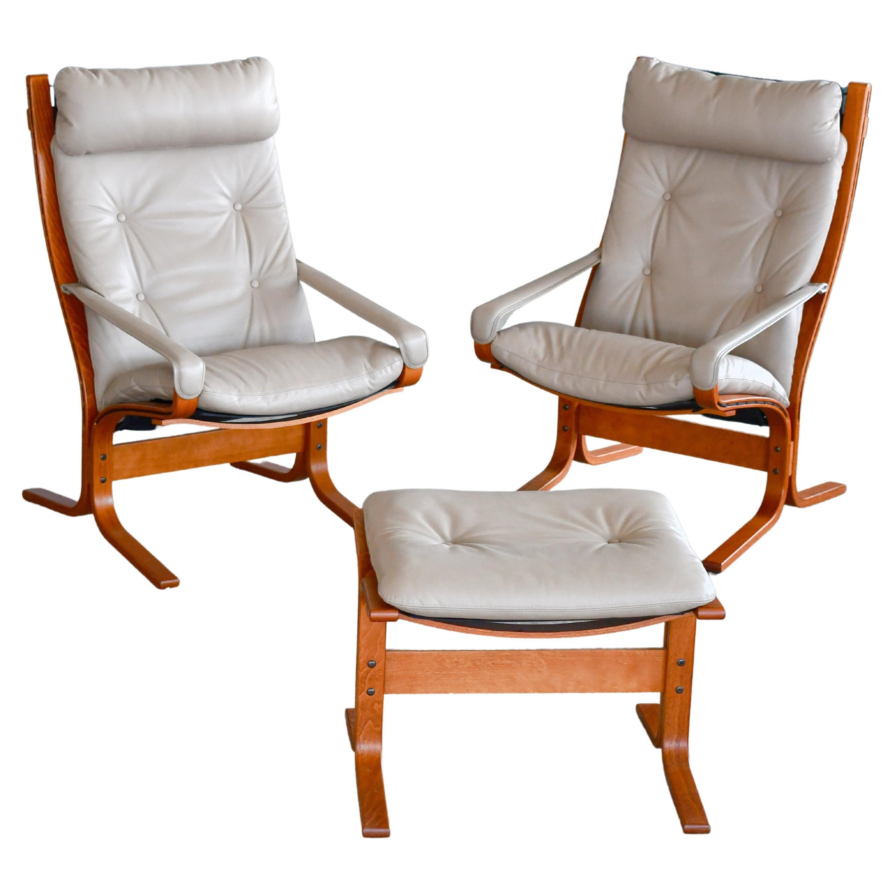 Pair of Relling Highback Siesta Chairs in Beige Leather with Matching Ottoman  For Sale