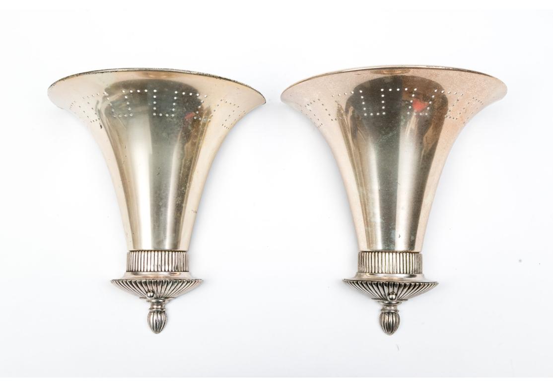 Pair of silver plate wall lamps by Remains Antique Lighting with pierced fan form design and reeded terminal. The shade with pierced geometric design that accentuates the emitting light from the interior. Retains the Remains Antique Lighting label.