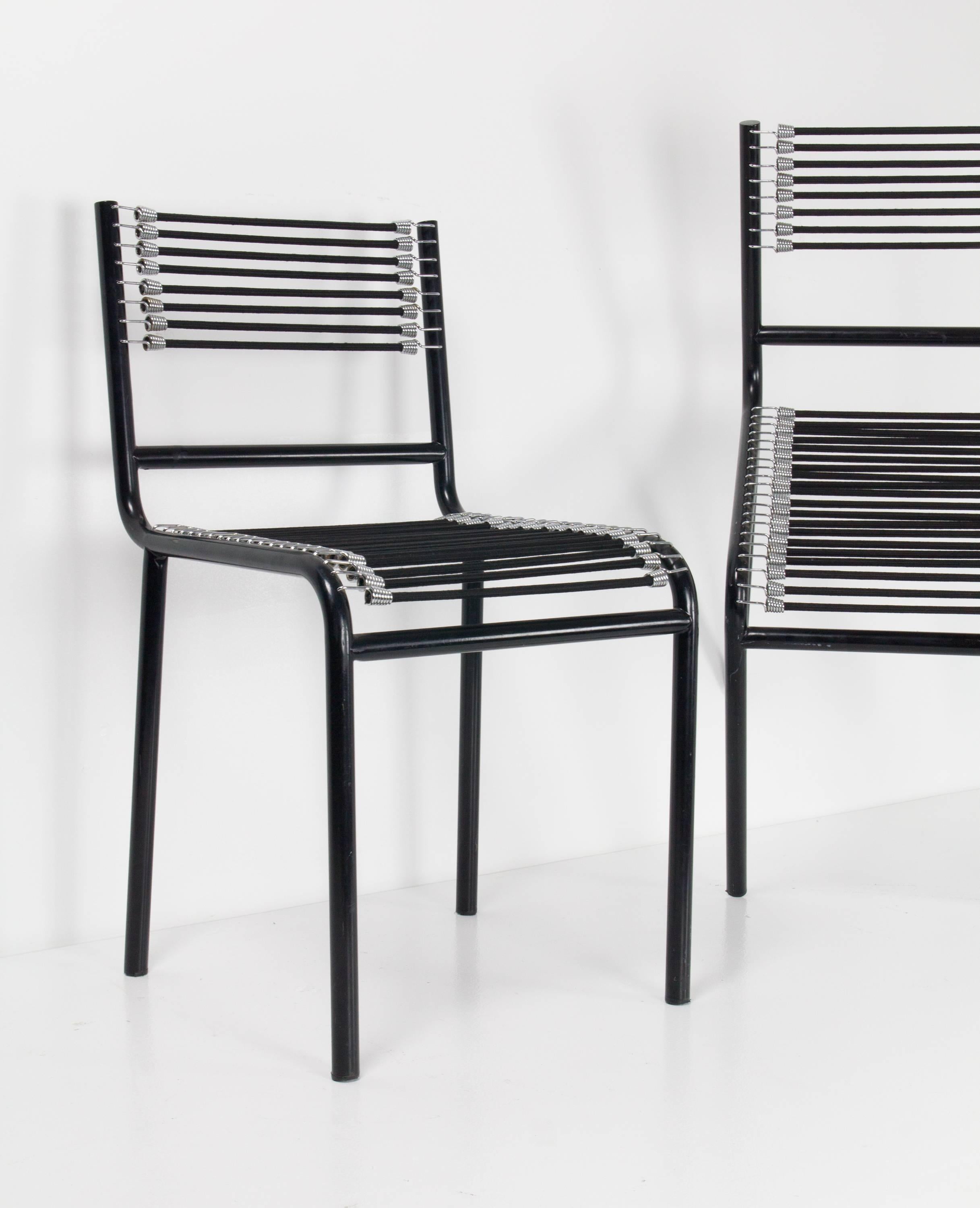 Pair of René Herbst Sandows chairs produced by Movimento Moderno with steel frames supporting elasticated straps as backrests and seats.