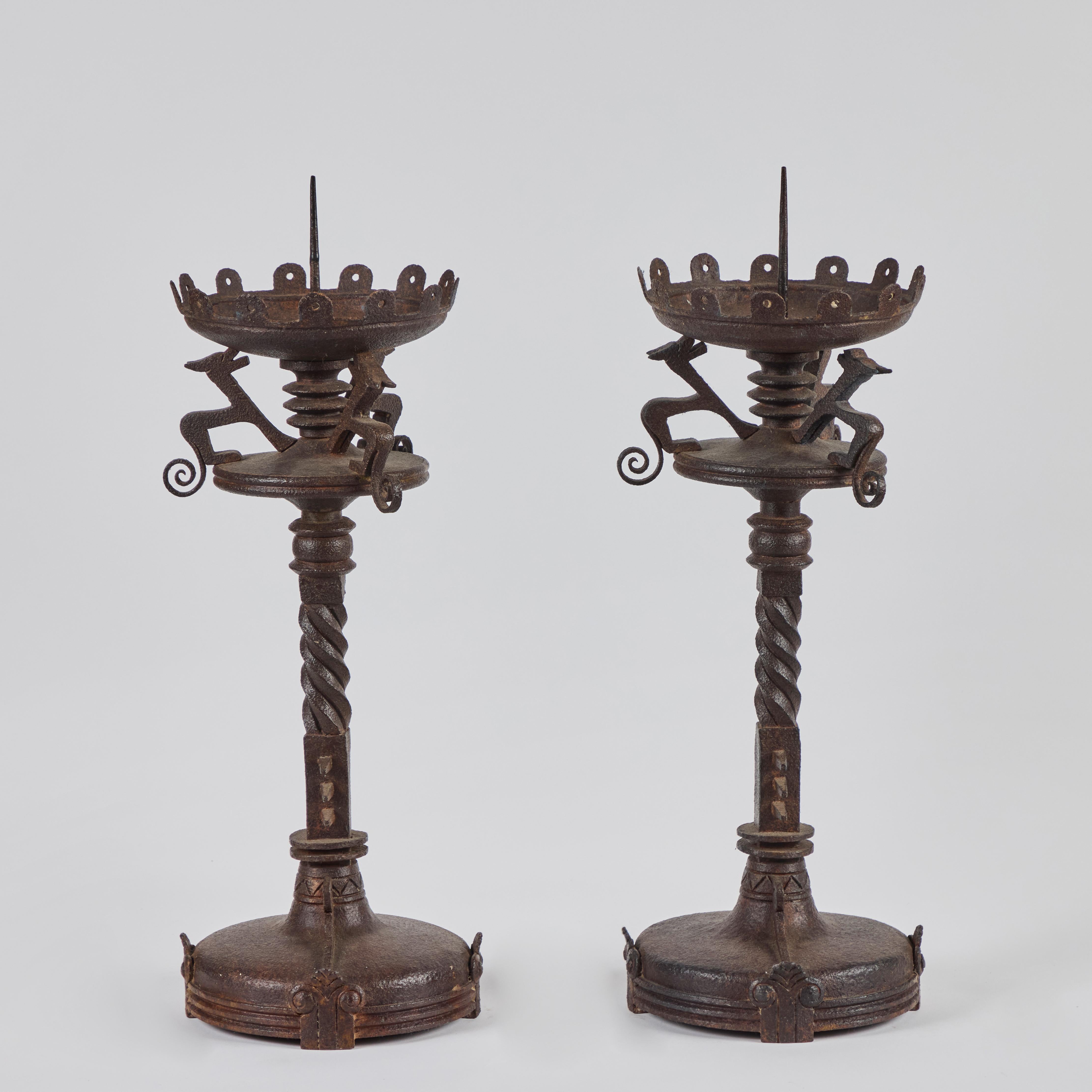 A pair of hand-forged, Renaissance Revival iron pricket sticks with removable bobeches.  22