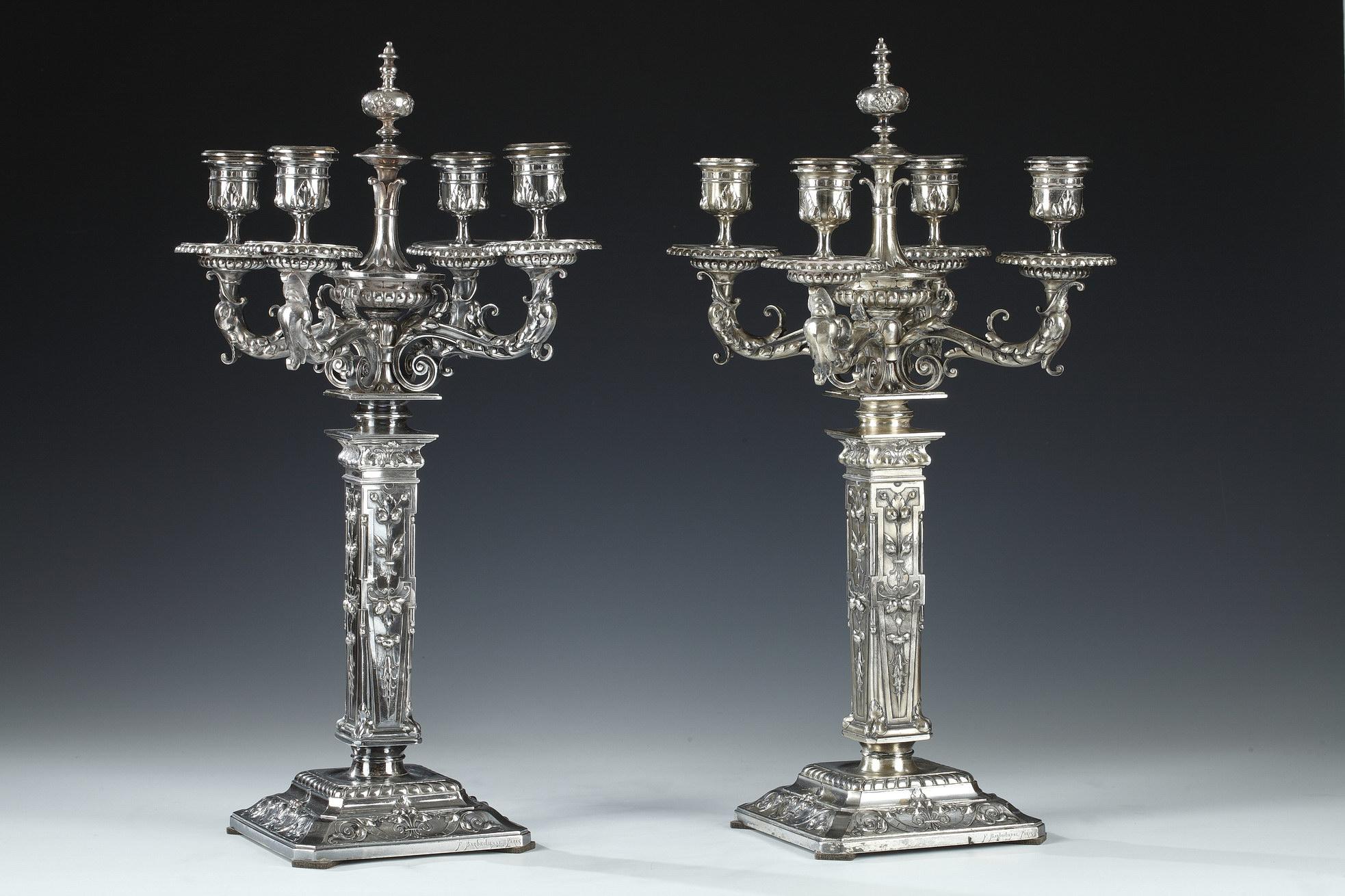 Signed F. Barbedienne Paris; D. Attarge Fit; C. Sevin inv 1869

Rare pair of Renaissance style candelabra with four light-arms in chiselled and silvered bronze, adorned with an elegant pattern of foliage and godrons. They rest on a square base