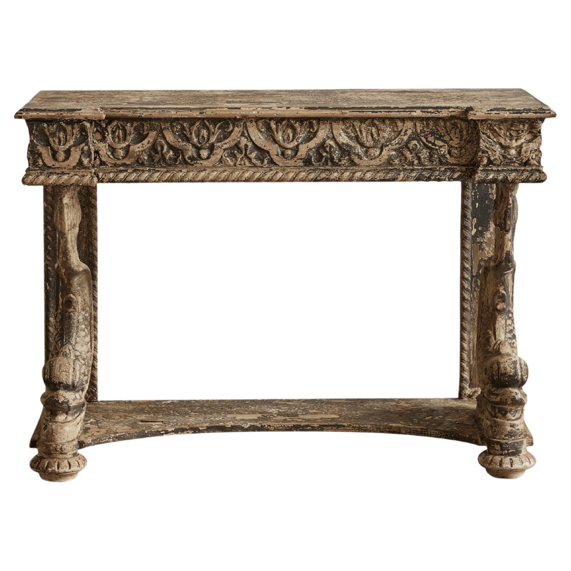 Pair of intricately carved renaissance style console tables from France circa 1970. Some visible wear throughout that is consistent with age and use.