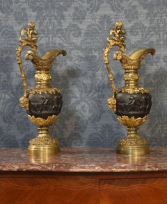 Pair of Renaissance style French patinated bronze ewers