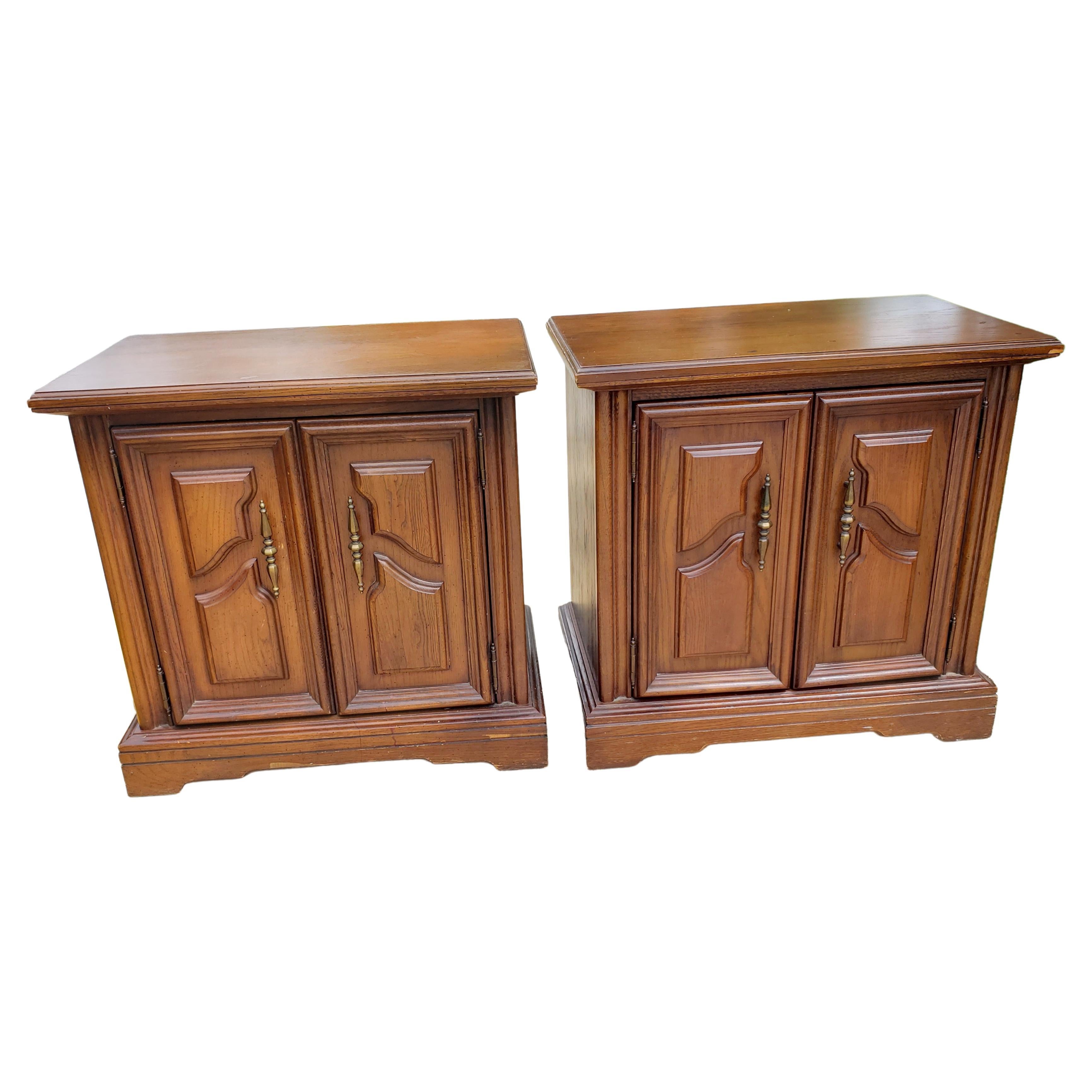 Pair of Renaissance style walnut side tables / nightstands.
Panelized French doors open to reveal a top dovetailed drawer and bottom large storage area.
Very good vintage condition.

W1060222E.