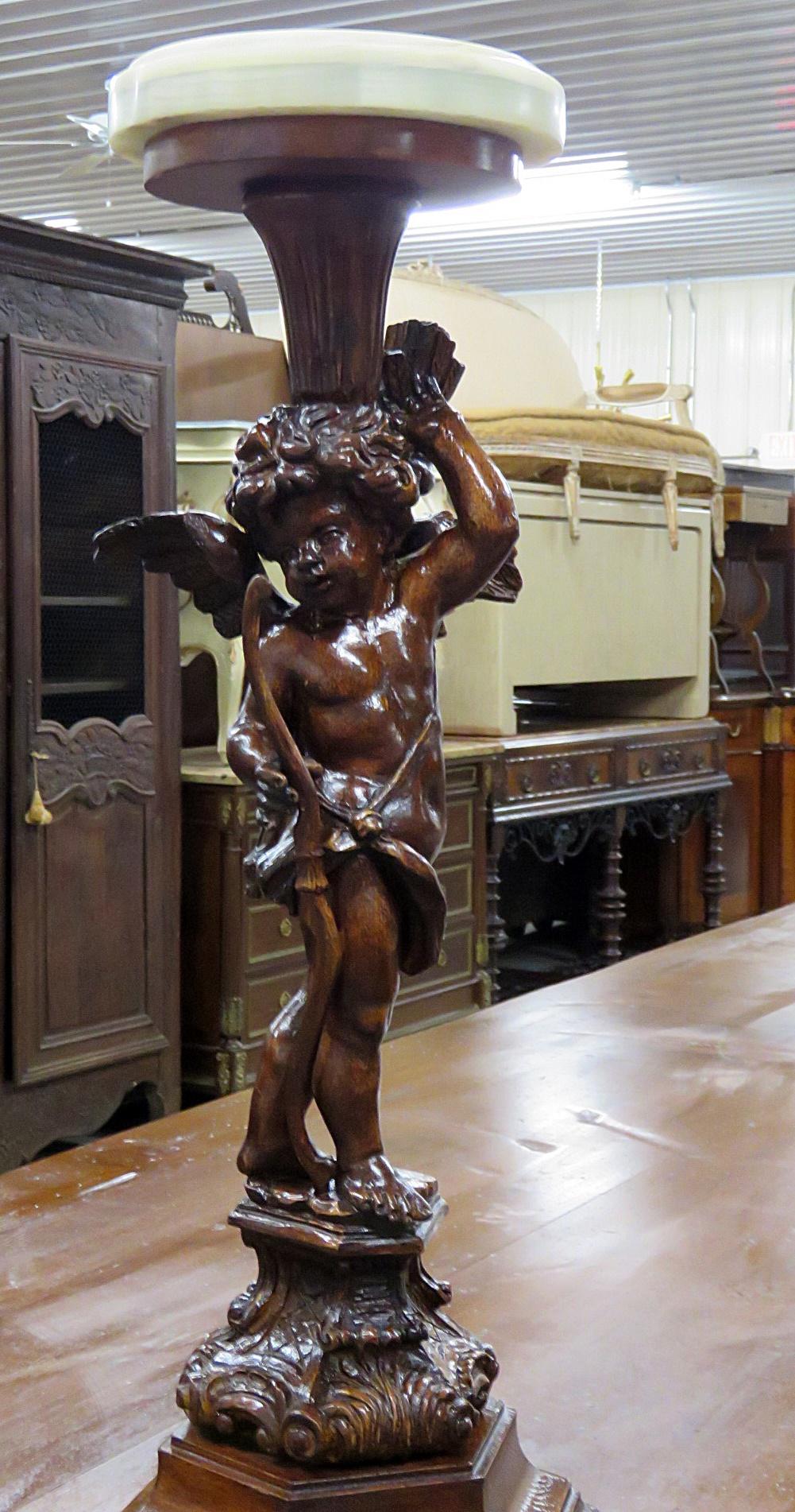 Pair of Renaissance style putti pedestals with onyx tops.