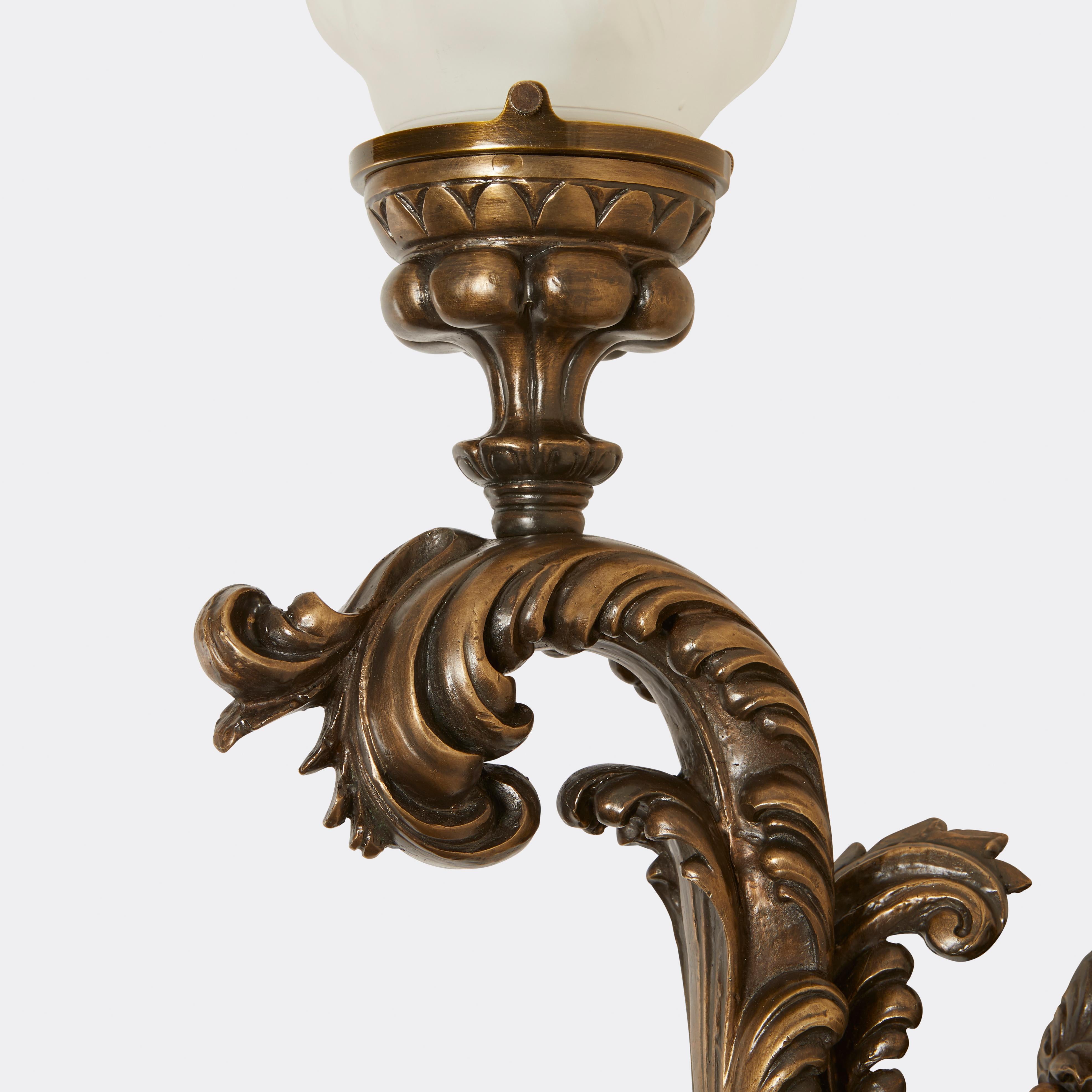 Pair of Renaissance style Torch Sconces cast in brass with glass flame globe. The sconces are from the Caldwell archives, which are made public through the Smithsonian Institute. Used in Stanford White interior.