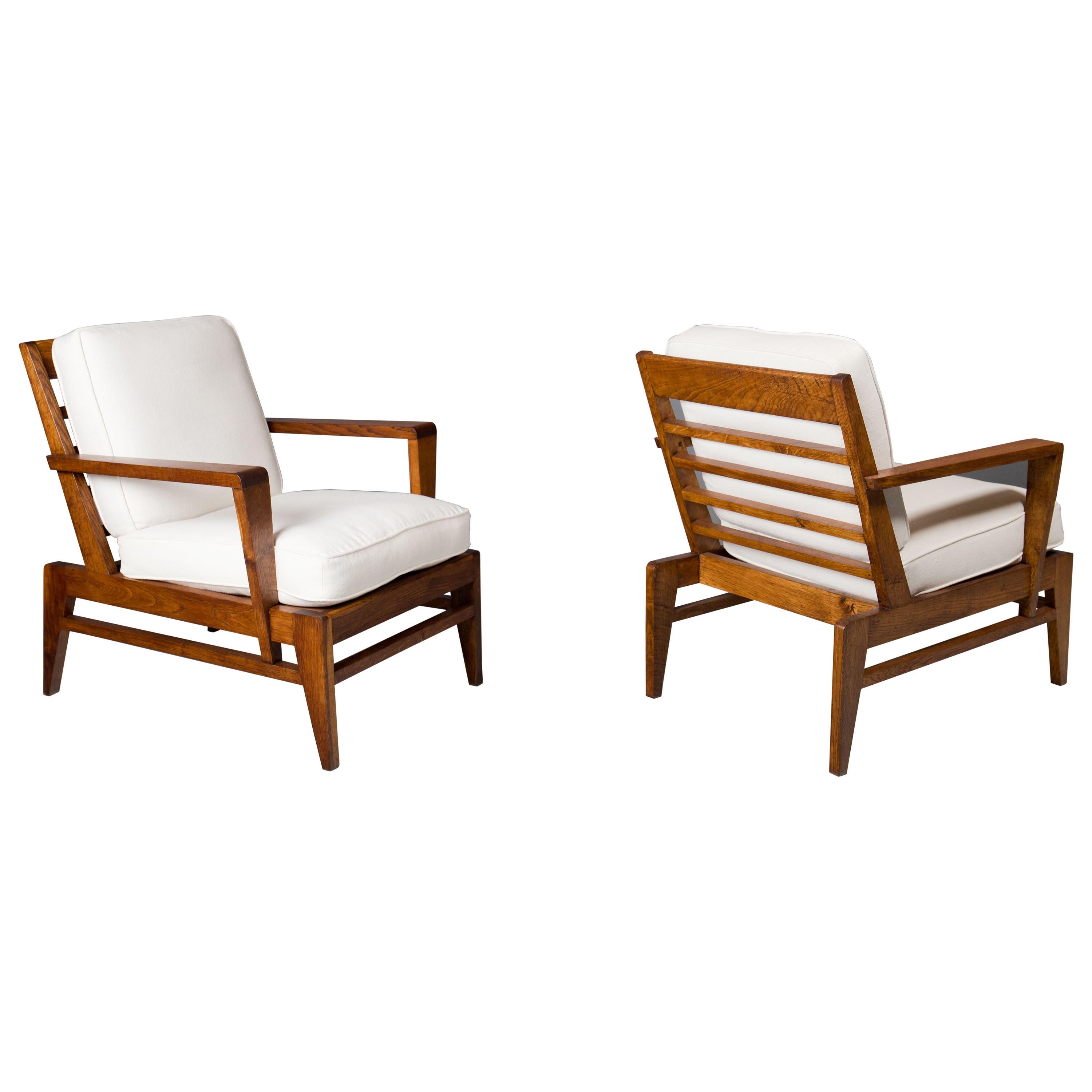 Great French, mid century lounge chairs by Rene Gabriel, ca 1950s.
Frames have been newly refinished with oil rubbed finish and original horsehair cushions have been recovered in white linen.