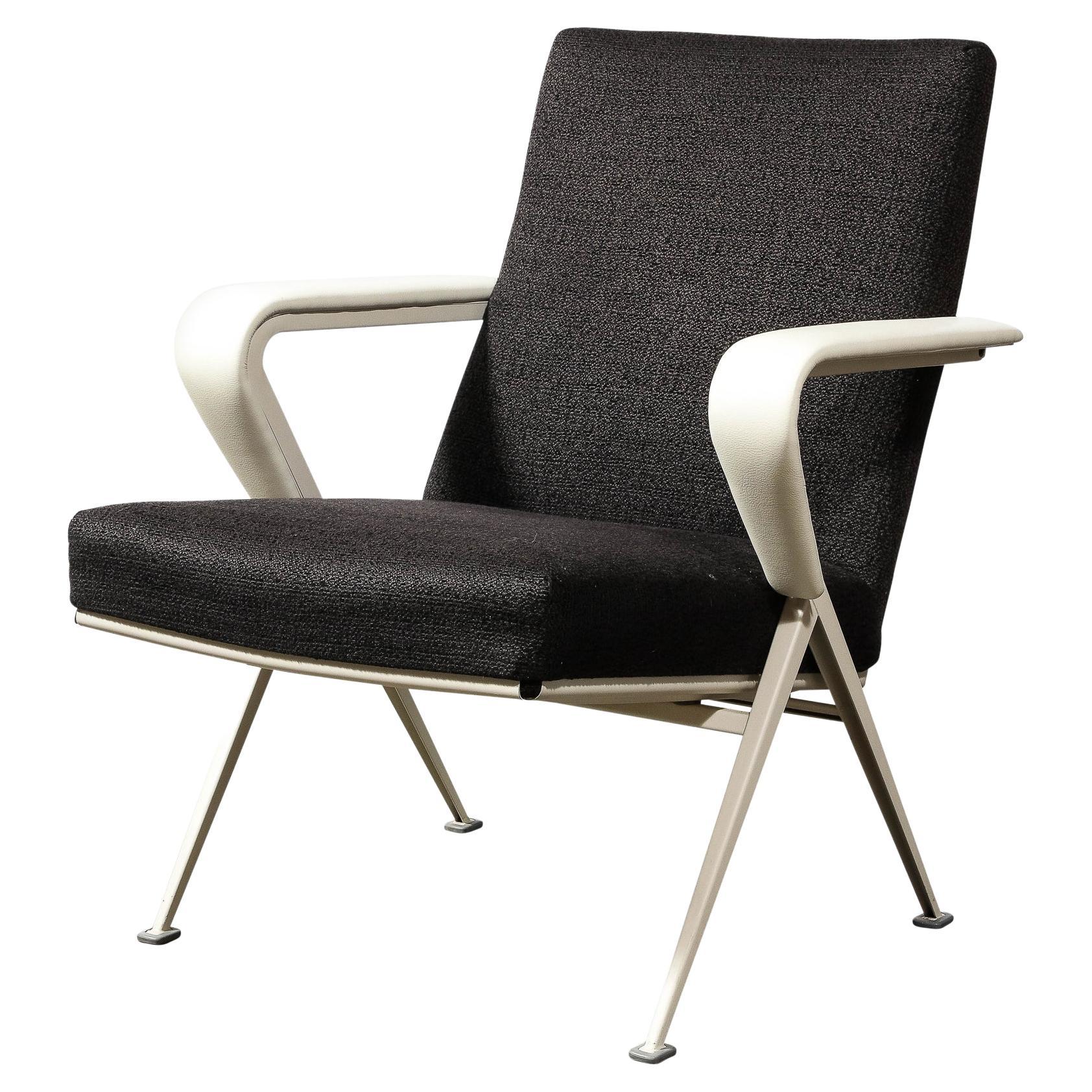This sophisticated pair of Mid Century Modern repose chairs were realized in the Netherlands circa 1960. They feature angular compass style legs with round feet in enameled steel and sculptural v-form arms with rounded interior angles clad in luxe