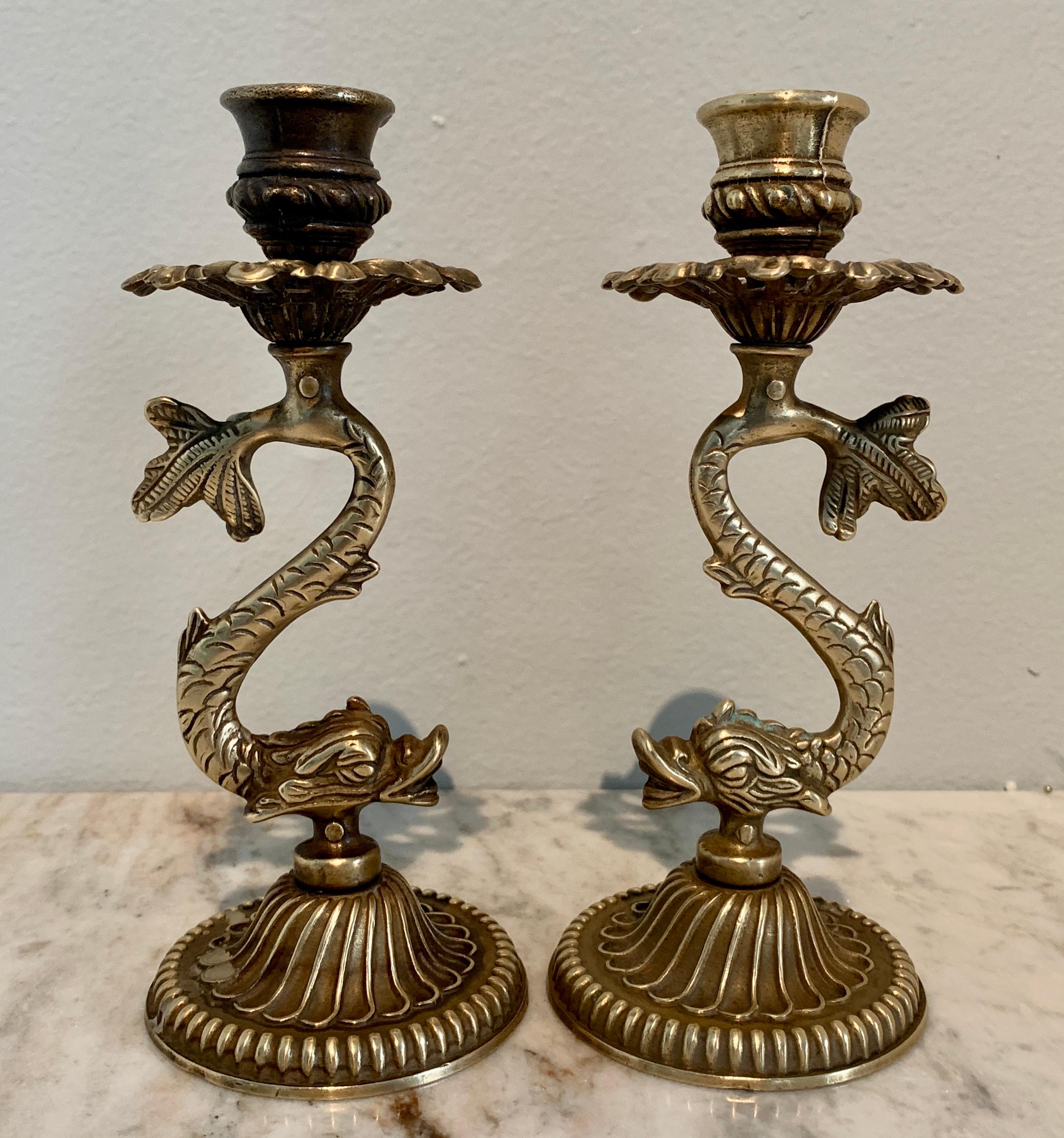 Mid-Century Modern Pair of Repoussé Brass Dolphin Candlesticks For Sale