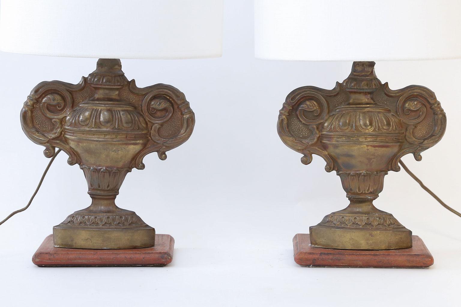 Pair of repousse tole lamps from 19th century gilt-tole fragments mounted on painted stands. Newly wired for use within the USA. Includes complementary linen shades (listed measurements include shades).