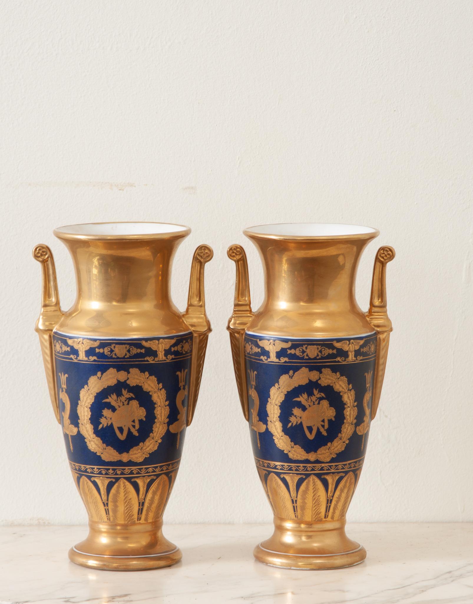 An impressive petite pair of Napoleon III Style vases. This newly made pair of vases are in wonderful condition and have a lustrous gold gilt finish. Be sure to view the detailed images for a closer look. Sold as a pair. 