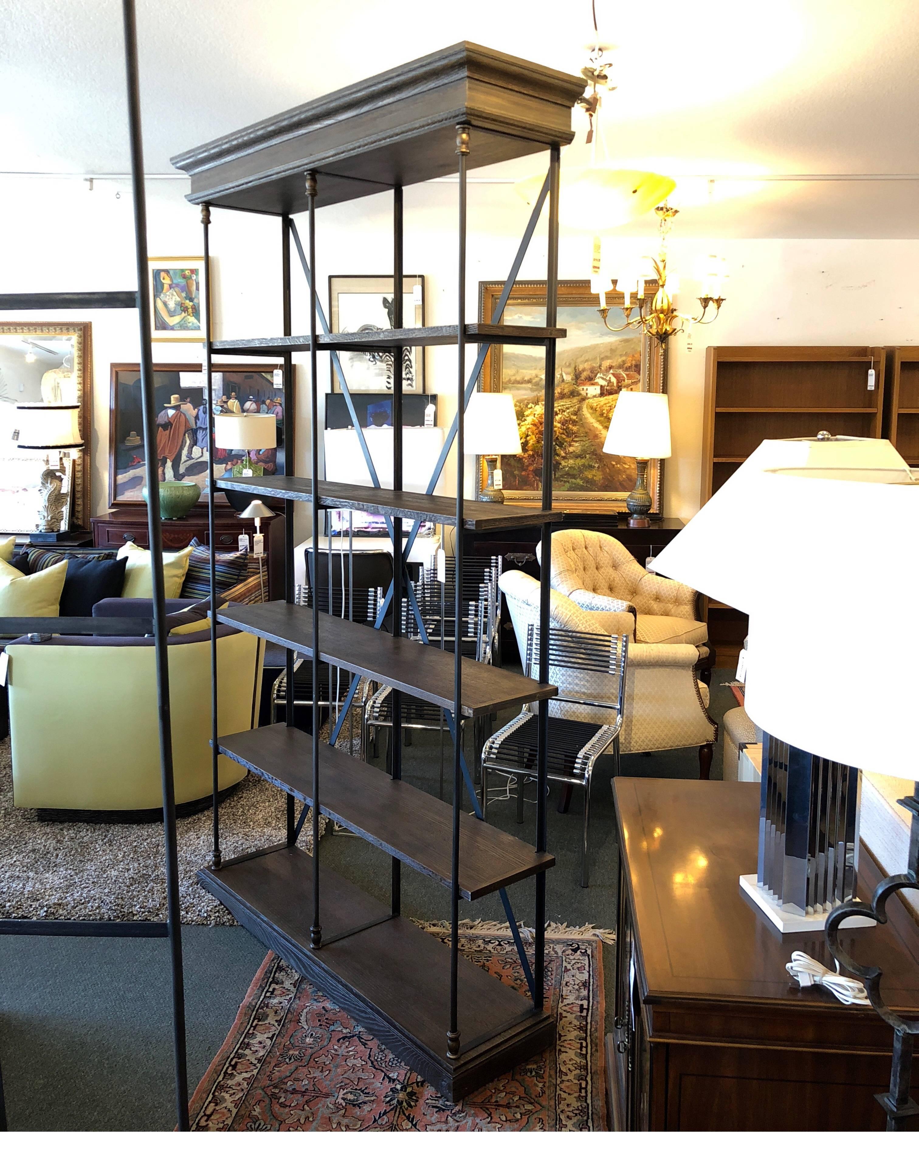 A pair of Parisian Cornish double shelving units from restoration hardware. Referencing the late 20th century postmodern movement by combining modernism with classical detail, this is a reproduction of a French original. The structural iron frame