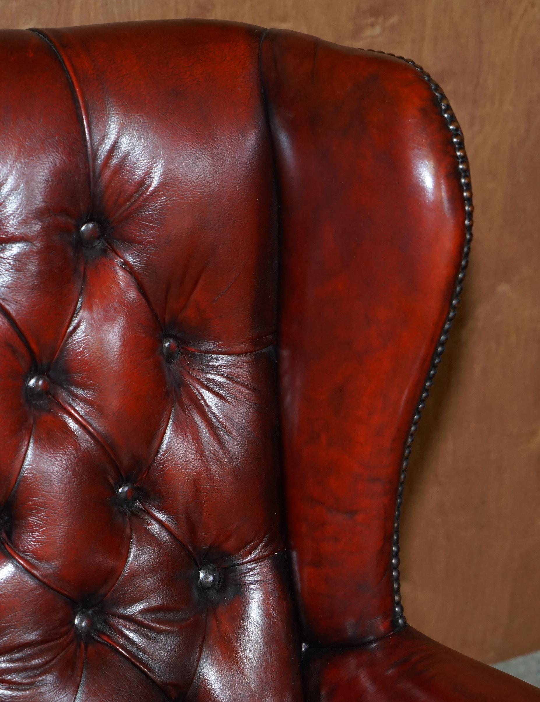 20th Century Pair of Restored Chesterfield Wingback Bordeaux Leather Armchairs & Footstools