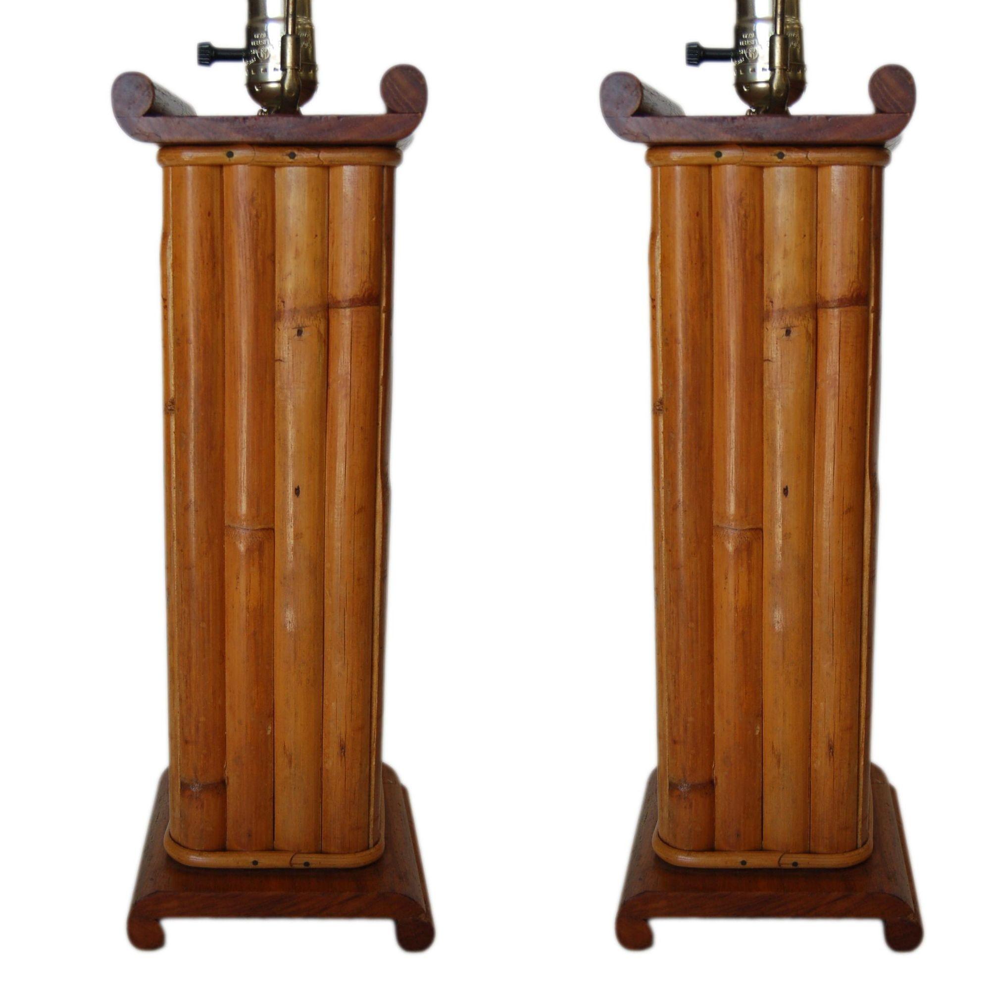 Pair of restored midcentury square scroll rattan table lamps featuring sixteen split decorative rattan poles fixed to a mahogany square top and base.

Measures 6