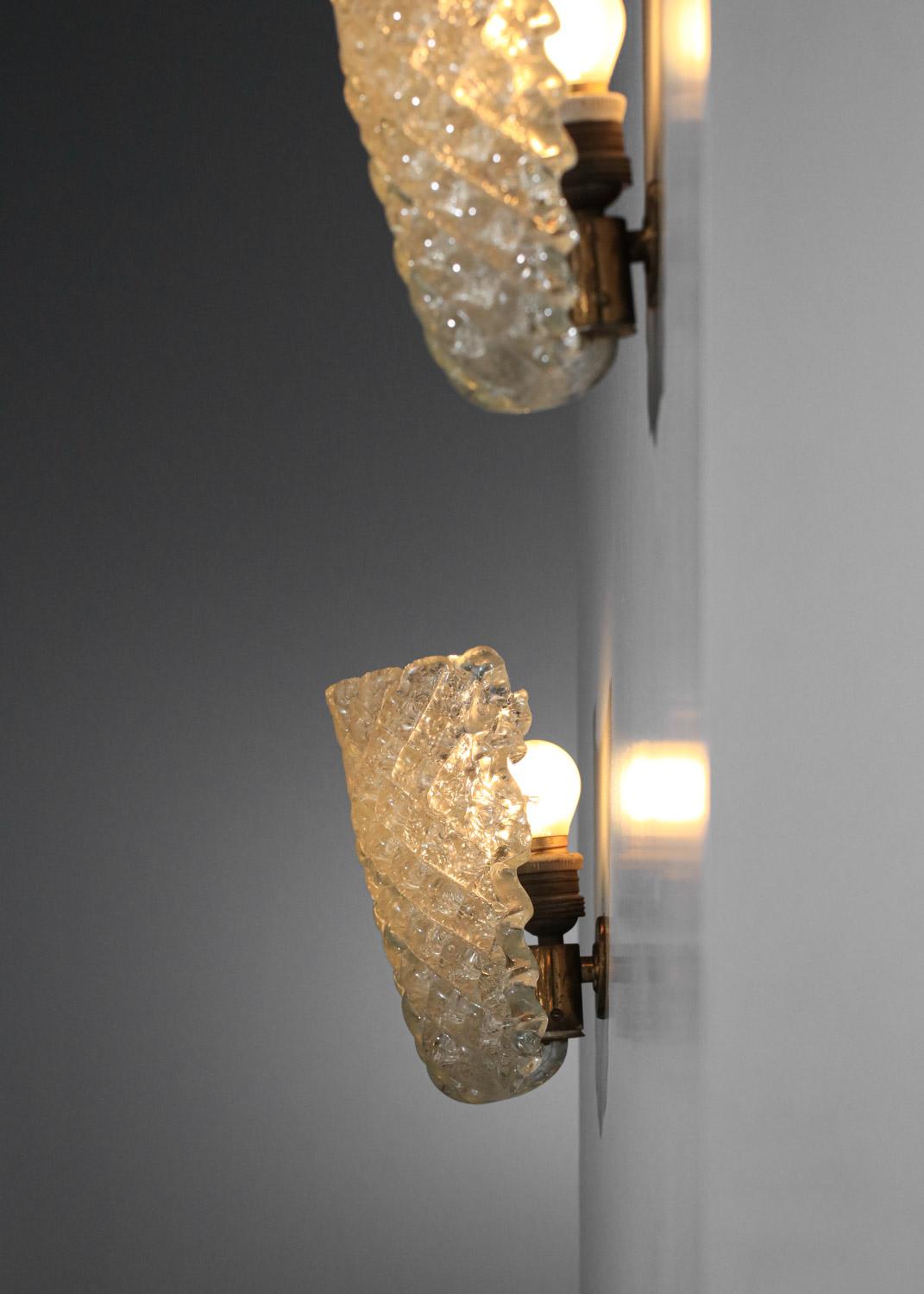 Pair of Italian wall sconces attributed to the Barovier&Toso manufacture. Solid brass hanging system and thick Murano glass shade with embossed texture. Very fine vintage condition, with traces of use and age (see photos). Note an old repair to the