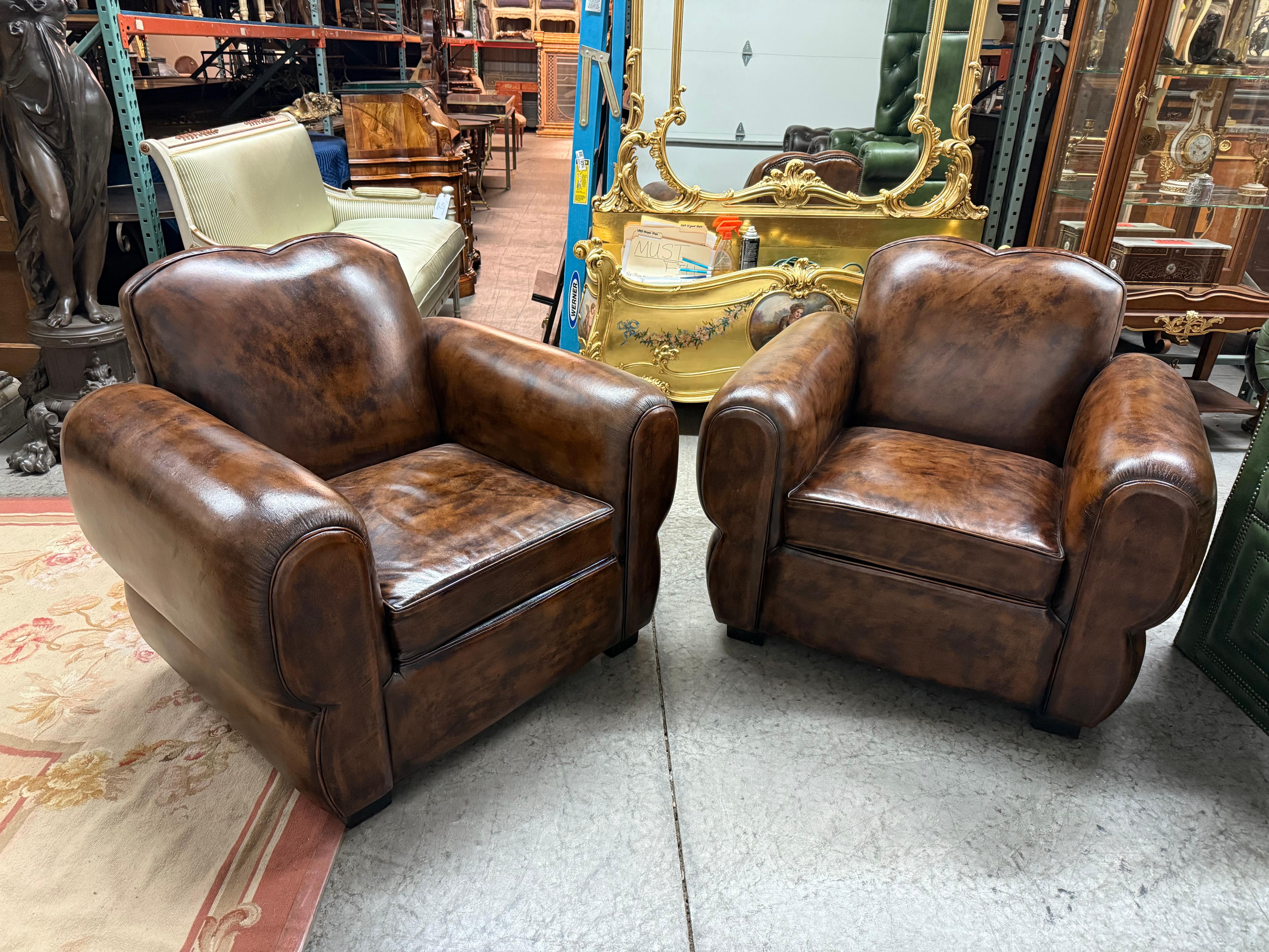 Step into the elegance of early 20th-century France with this stunning pair of restored 1930s French mustache cigar club chairs, also known as Art Deco club chairs. Crafted during the golden age of French design, these chairs embody the bold,