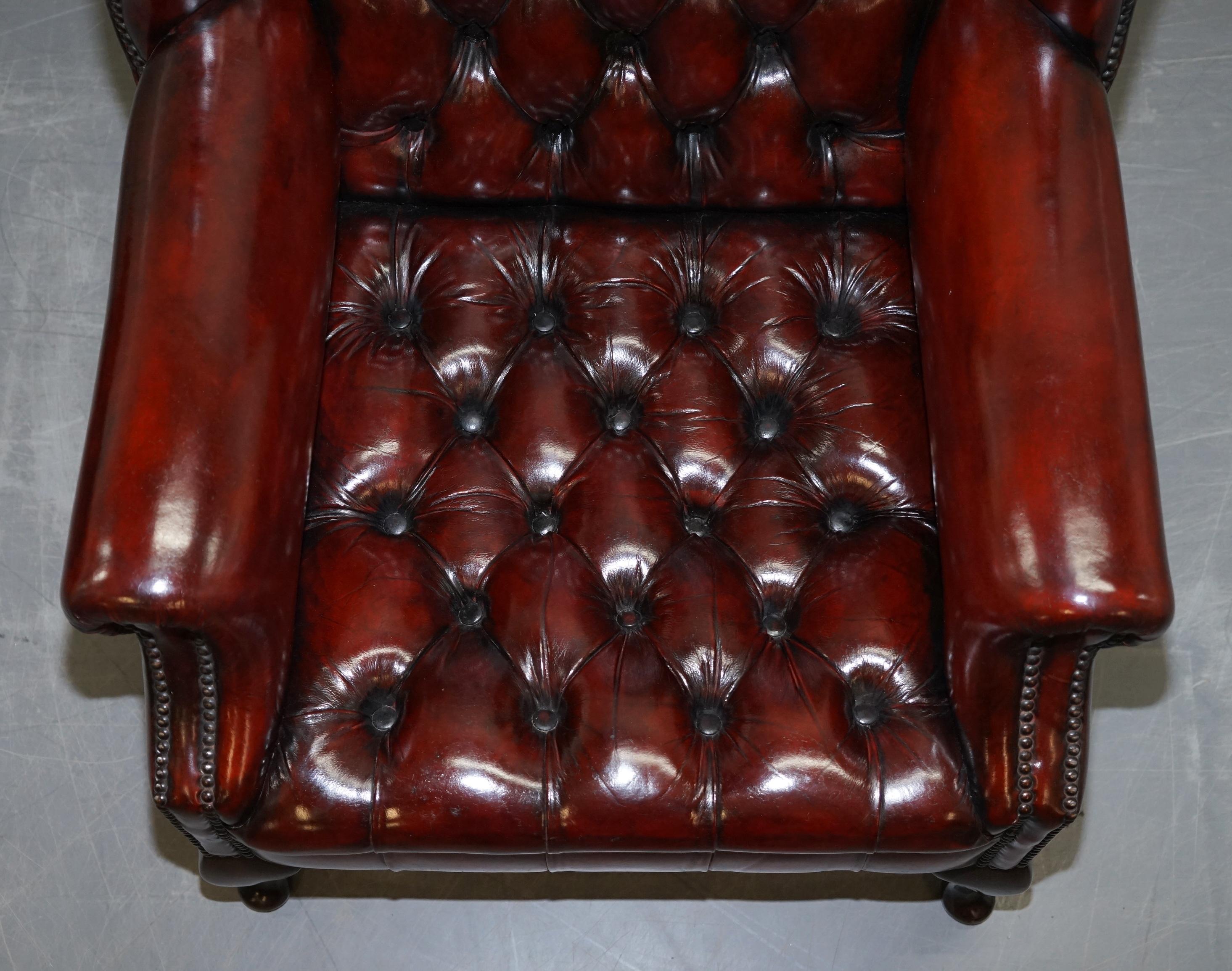 English Pair of Restored Oxblood Leather Fully Tufted Chesterfield Wingback Armchairs