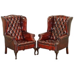 Vintage Pair of Restored Oxblood Leather Fully Tufted Chesterfield Wingback Armchairs