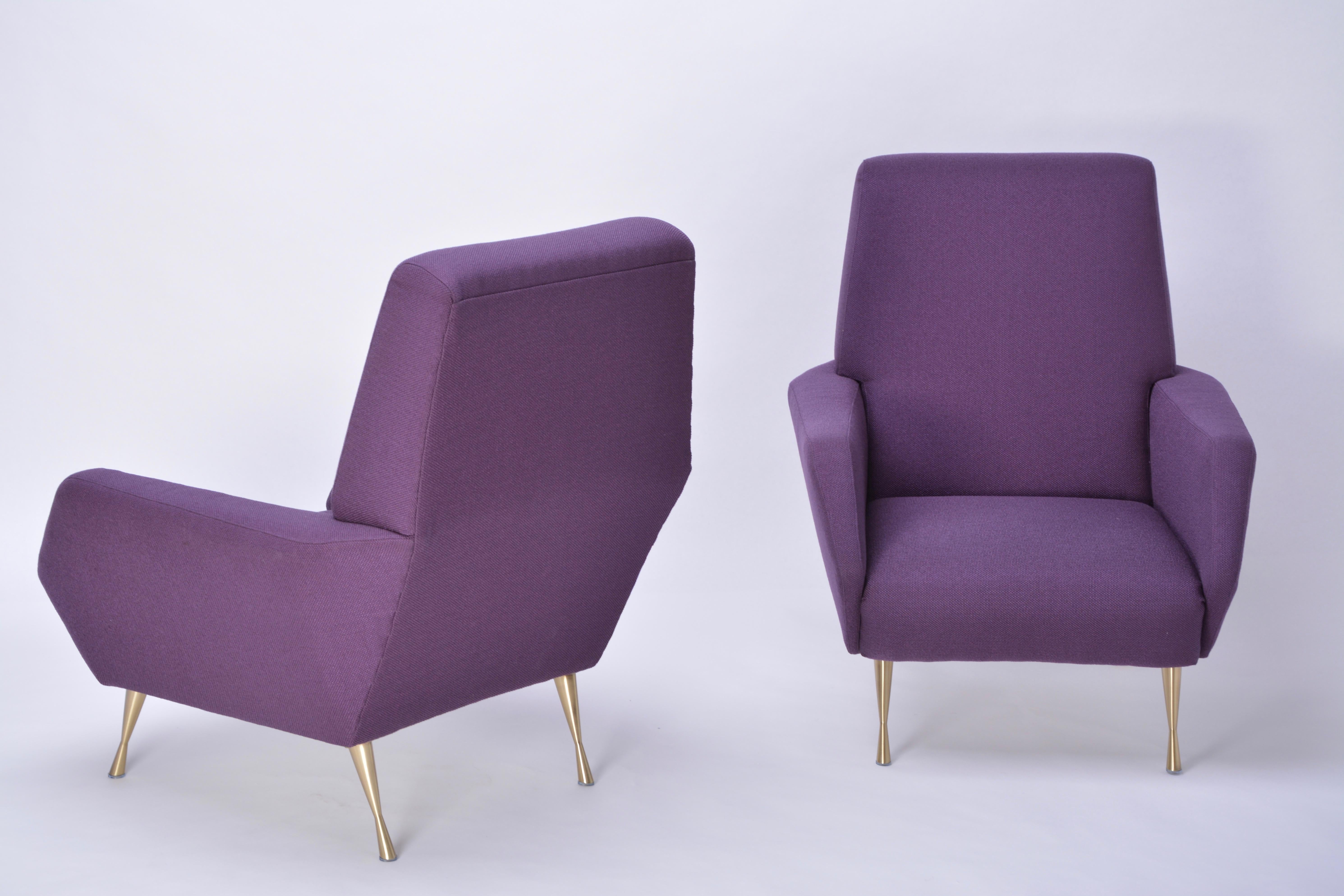Pair of reupholstered Mid-Century Modern purple Italian lounge chairs

This pair of lounge chairs was produced in Italy in the 1950s. It has been completely reupholstered in purple fabric and has new brass feet.