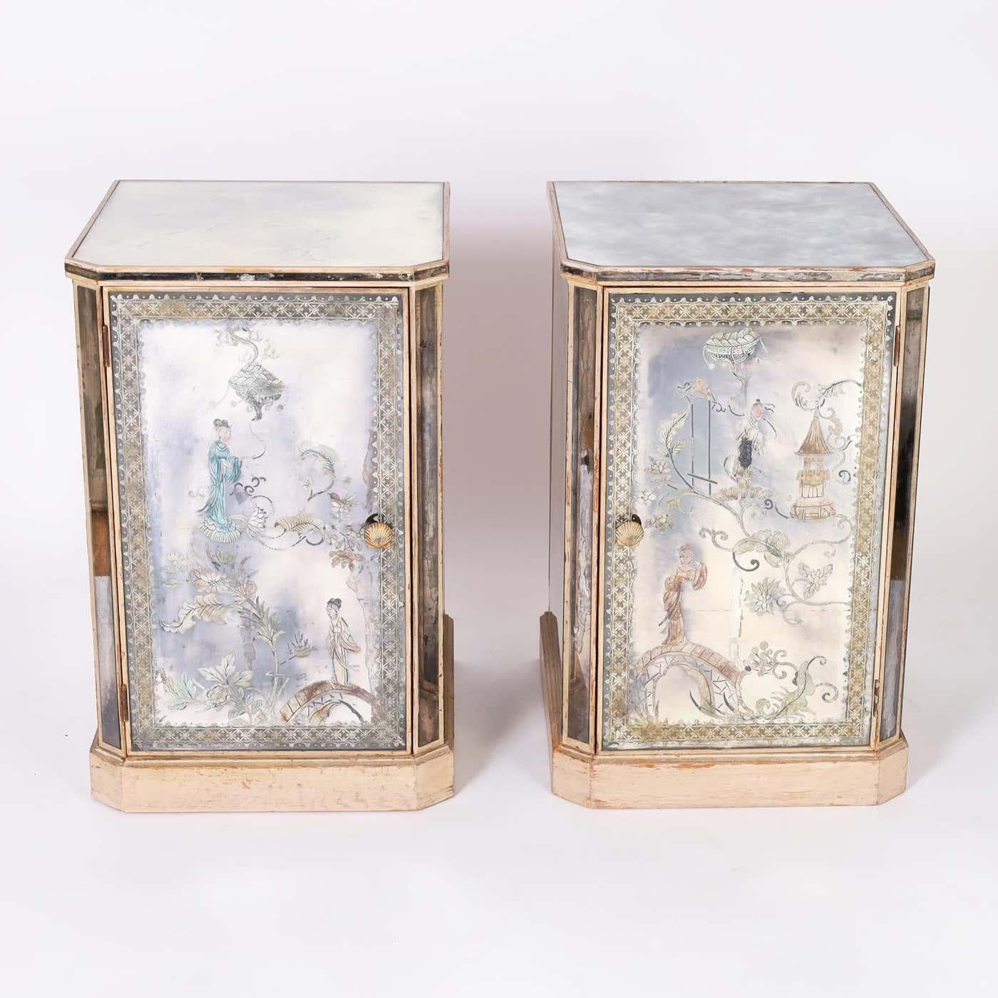 Pair of Italian art deco églomisé nightstands with distressed mirrored panels decorated in a reverse painting technique with chinoiserie designs on the fronts and three sides, one side replaced and one panel has two cracks. The doors have the