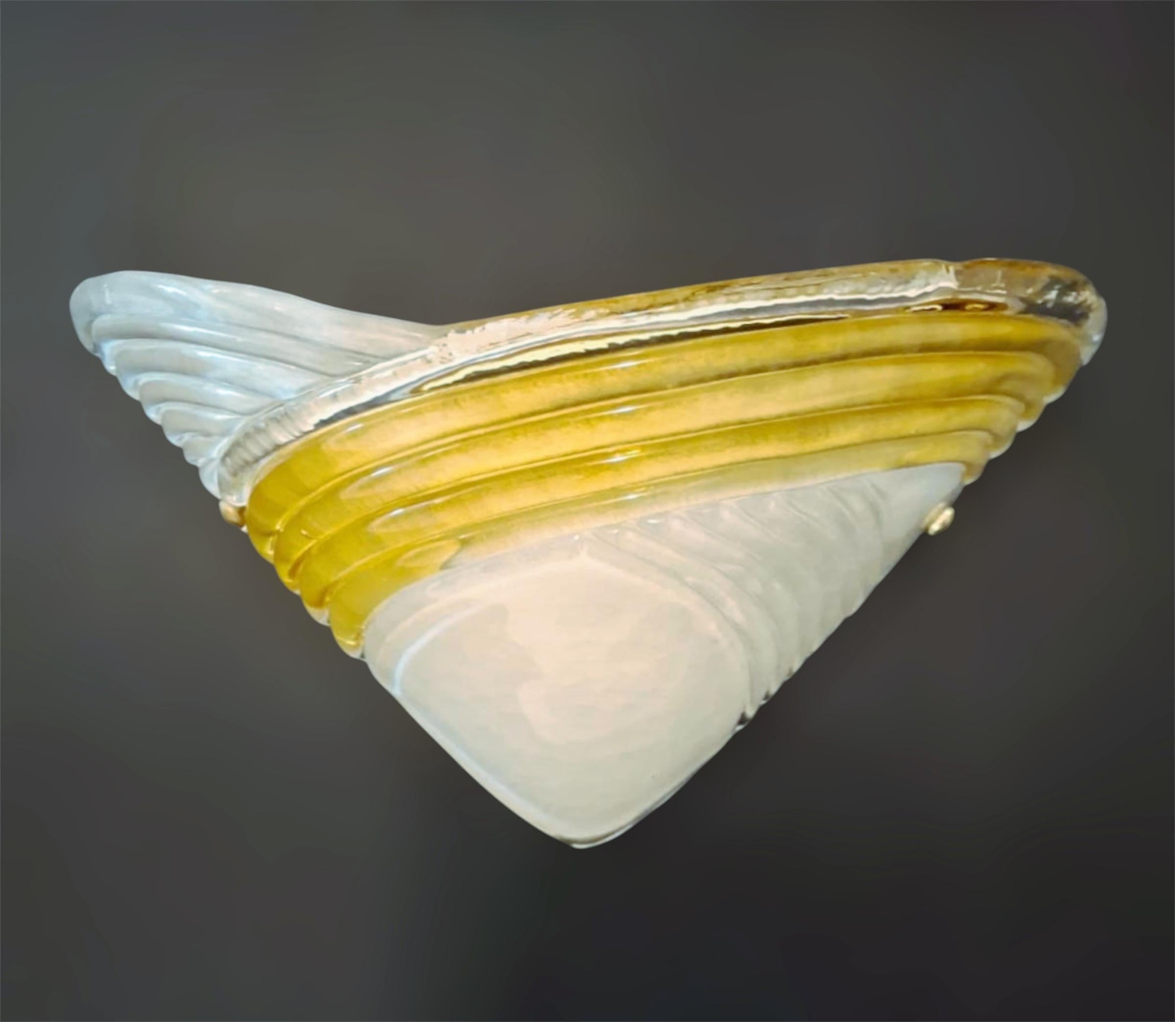 Vintage pair of Italian wall lights with frosted white Murano glass shades and amber ribbed band / Made in Italy in the style of Mazzega, circa 1960s
Measures: height 8 inches, width 15.5 inches, depth 8 inches
1 light / E26 or E27 type / max
