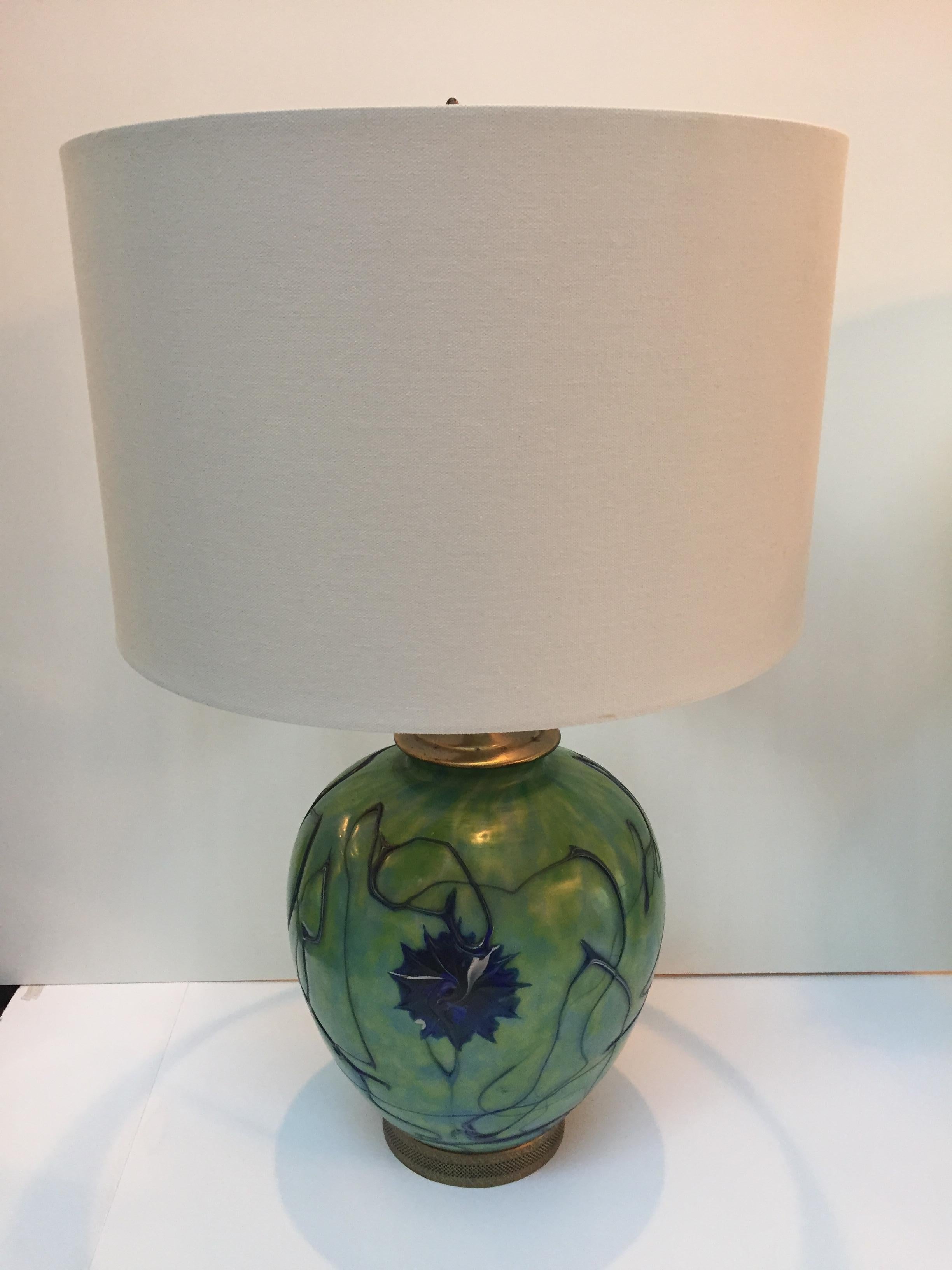 Pair of Pallme-Koenlg glass vases turned into lamps, having an Art Nouveau style and collectible iridized green glass with abstract glass trails in dark blue that wind around the circumference in a lyrical manner. 
Measures: 17 inches high to top