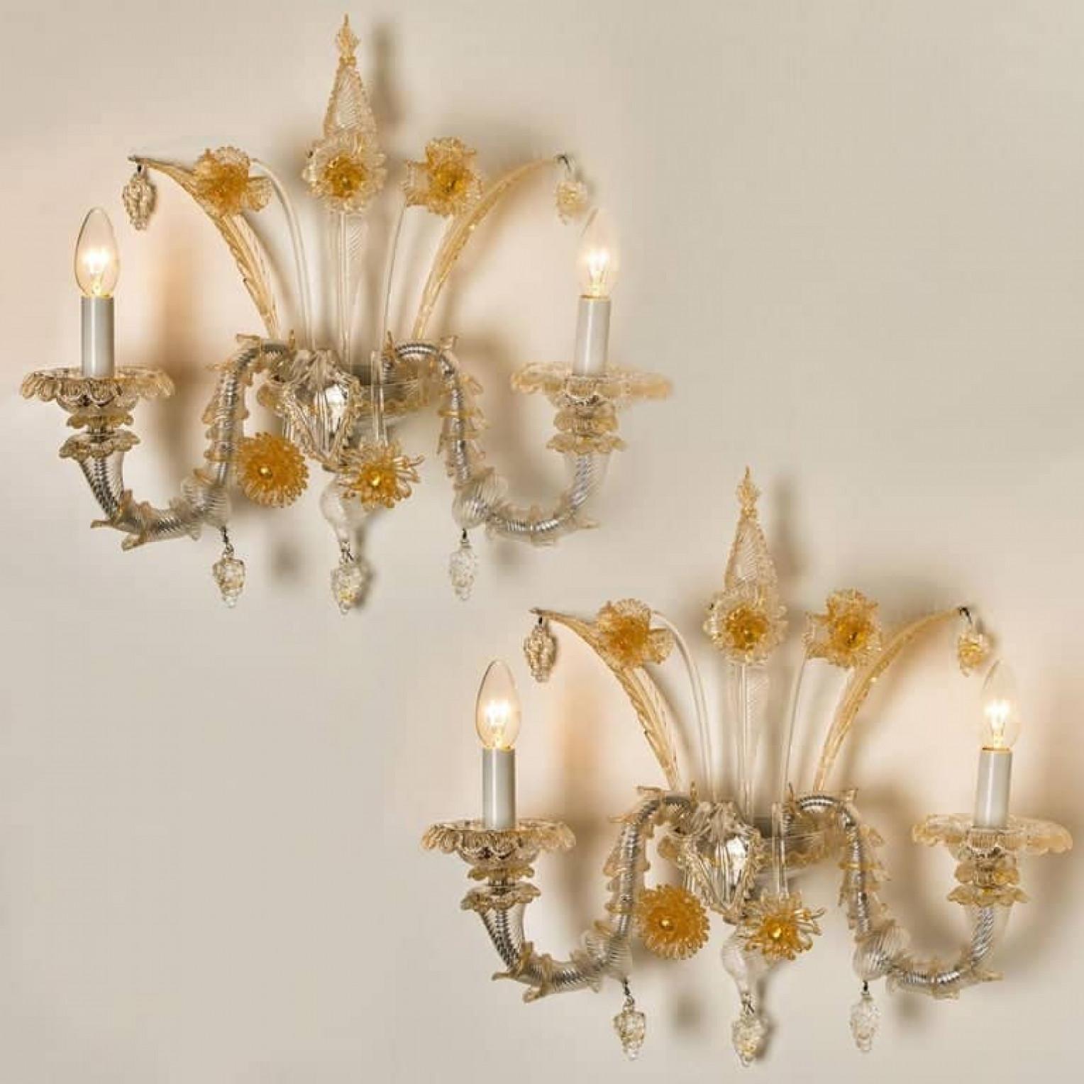 A truly rare and outstanding pair of wall lights, the lights are handmade in ribbed and curled colorless glass with aventurine inclusions. Statement pieces. Beautiful craftsmanship, Venice, Murano, circa 1960.

With grey metal mounting, central
