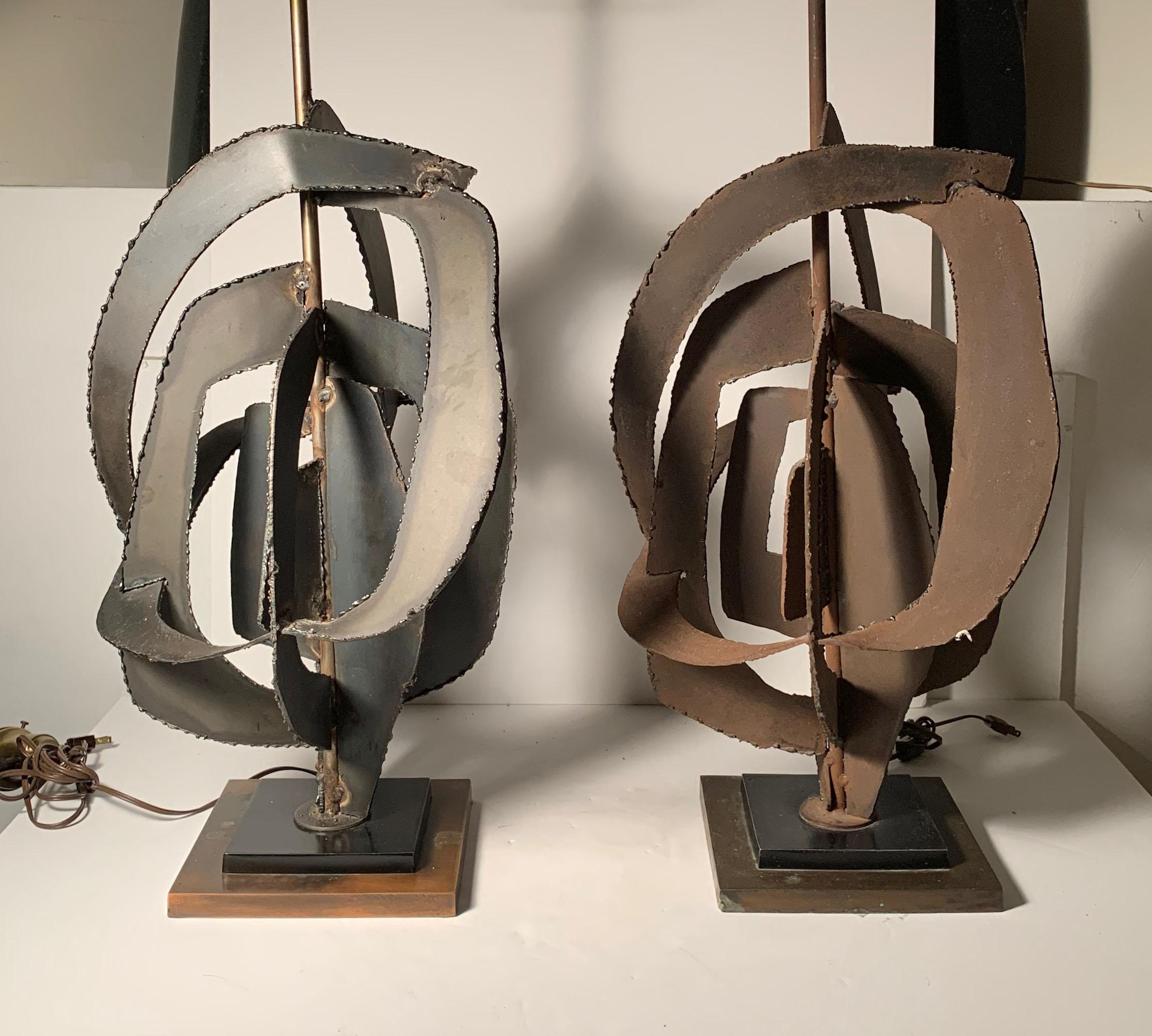 Pair of Richard Barr Brutalist lamps for Laurel. Price is for pair.

Finish on one has a light rust all-over. The other is more black. The lamps are matching. The design is based off a template.