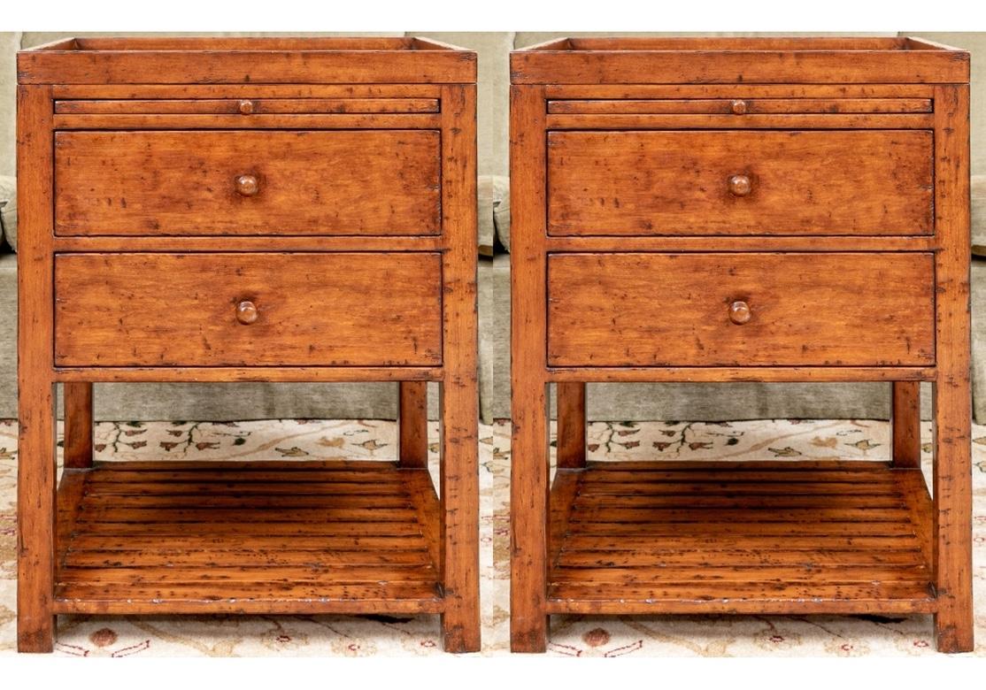 Pair of Richard Mulligan two drawer end tables with pull out tray and planked lower tier. The cases have a Honey tone with intentional burns and the tops are galleried trays that lift-off. Brass plaques with designer’s name and year produced affixed