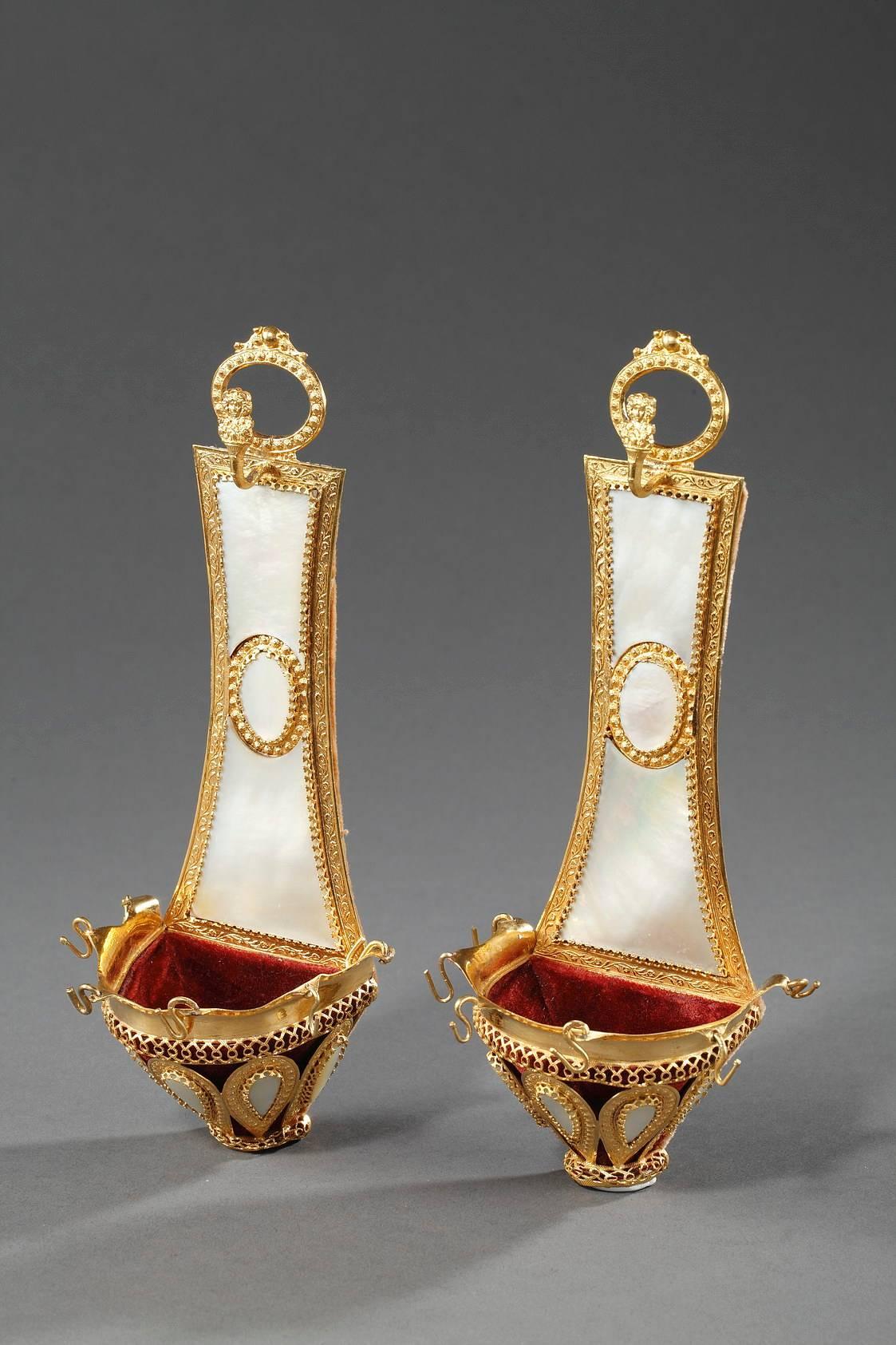 Pair of Charles X ring holders (baguiers) with ormolu mounts embellished with small flowers. A high backing of mother-of-pearl joins a small, ormolu bowl featuring openwork interlacing and teardrop-shaped mother-of-pearl gadroons surrounded by gilt