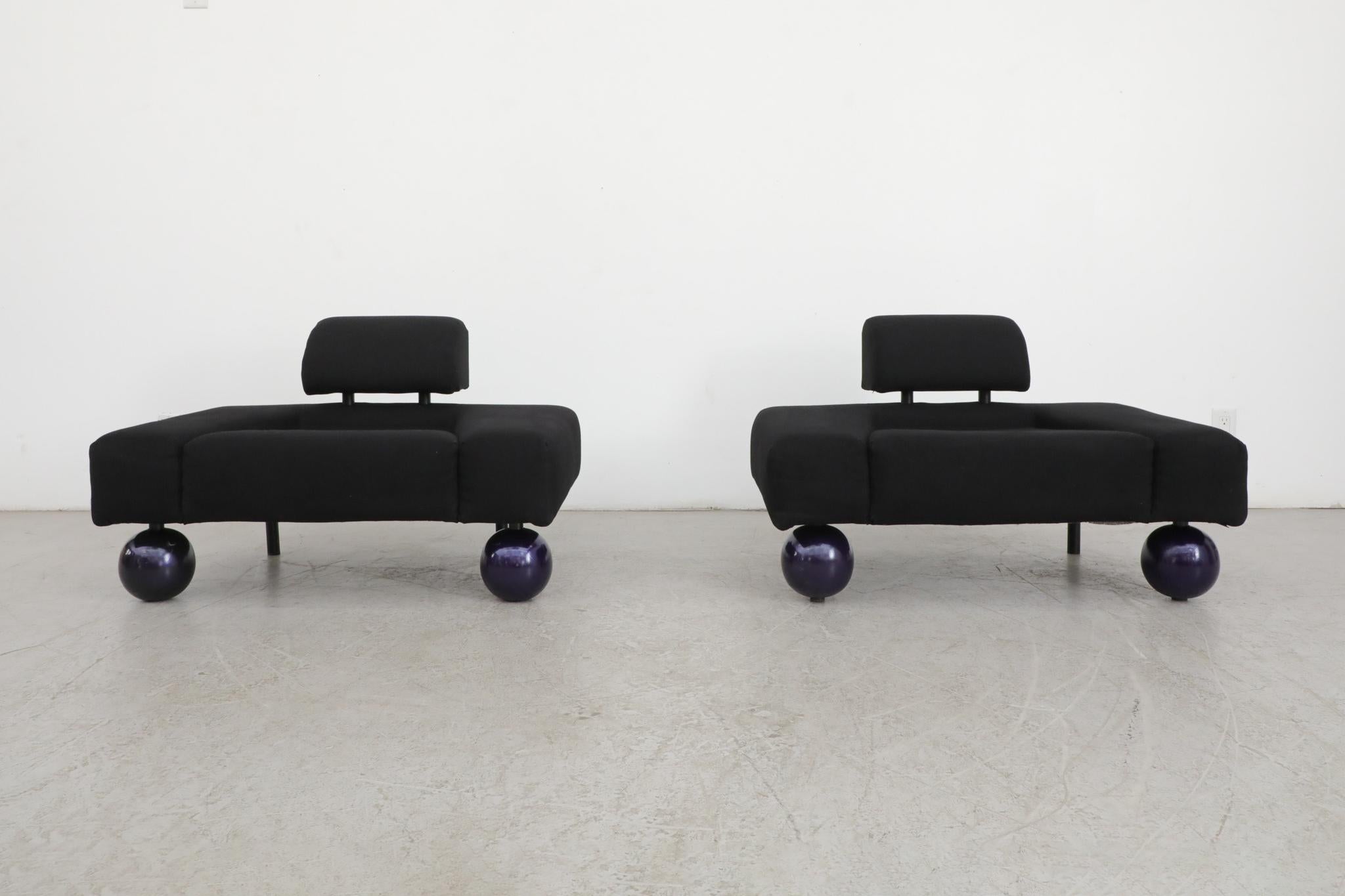 Awesome pair of Rob Eckhardt 'Garni' lounge chairs for Pastoe, 1986. Original black fabric with removable backrests and black enameled metal legs fitted with purple lacquered wood ball feet. A visibly unique design with comfort and style as the