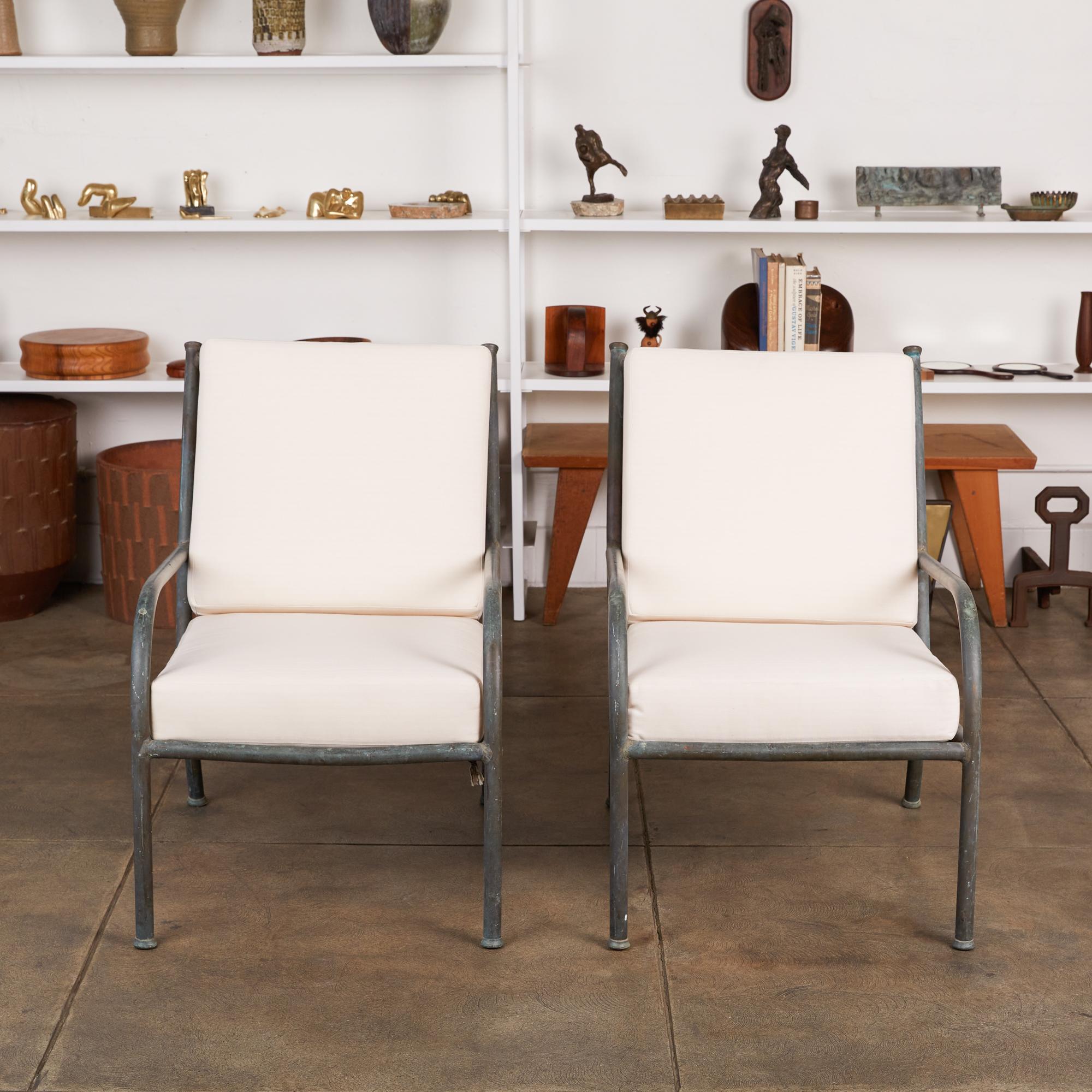 A pair of California-made bronze patio lounge chairs by Walter Lamb antecedent, Robert Lewis, c.1940s. The chairs feature a patinated bronze tubing frame with new Sunbrella back and seat cushions that are supported by woven rope.

Dimensions: