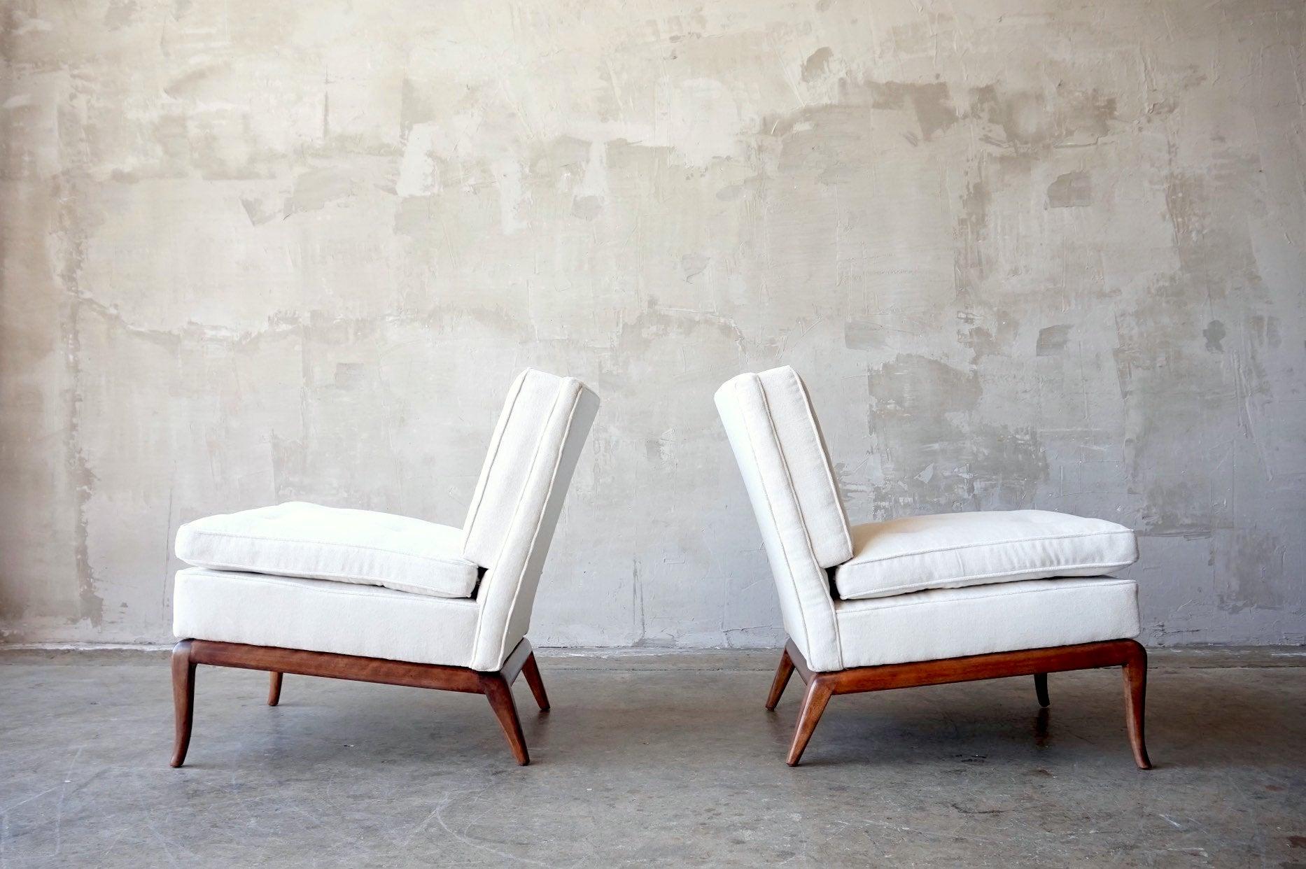 Pair of slipper chairs designed by Terrance Robsjohn-Gibbings for Widdicomb, circa 1960s. 

Upholstered in a vintage white cream colored thick cotton velvet. Walnut bases restored. 

Each measures; 24.5”W x 31”H x 31”D. 
Seat height; 18”.