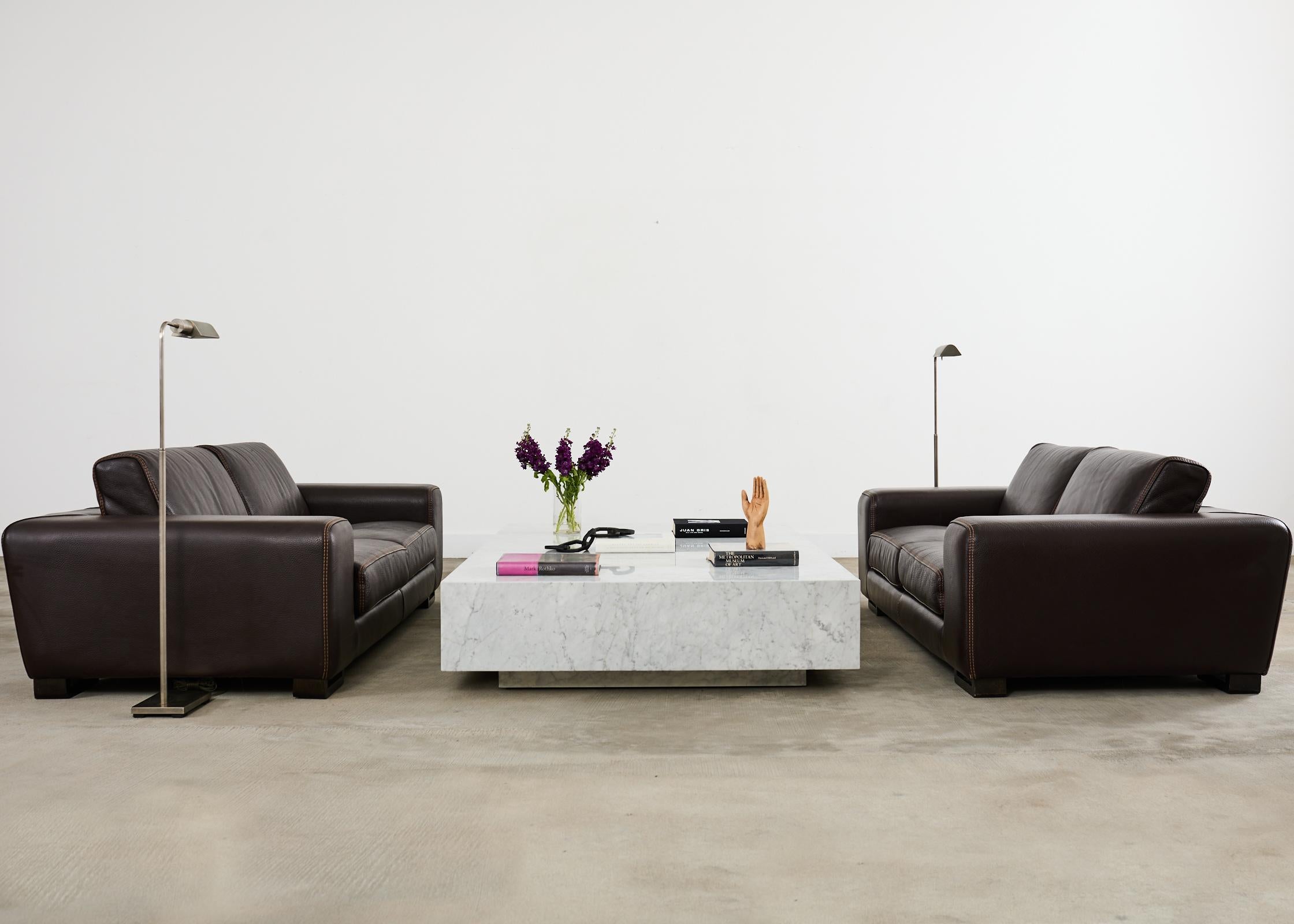 Amazing near pair of Italian Roche Bobois Chocolat sofas featuring thick Alpilles pebble grain leather. This bespoke near pair of sofas are custom made in different lengths which is difficult to see. One is 78 inches long the other is 85 inches
