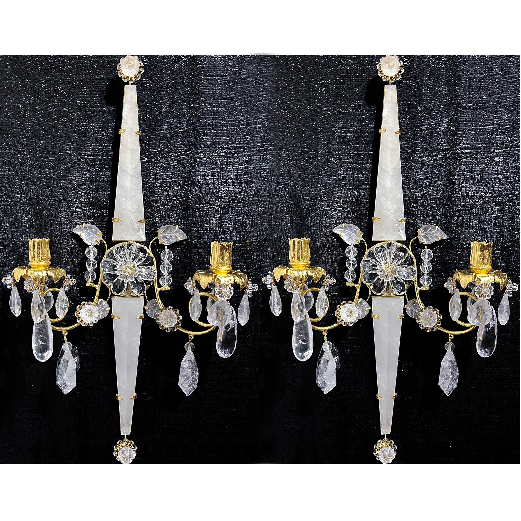 Pair of rock crystal two light sconces with large Triangle cut crystal pieces, in a star shape with floral center piece and a carved leaves. Two gilt bronze branches outstretch from the center flower, holding two gilt bronze flowers which will carry