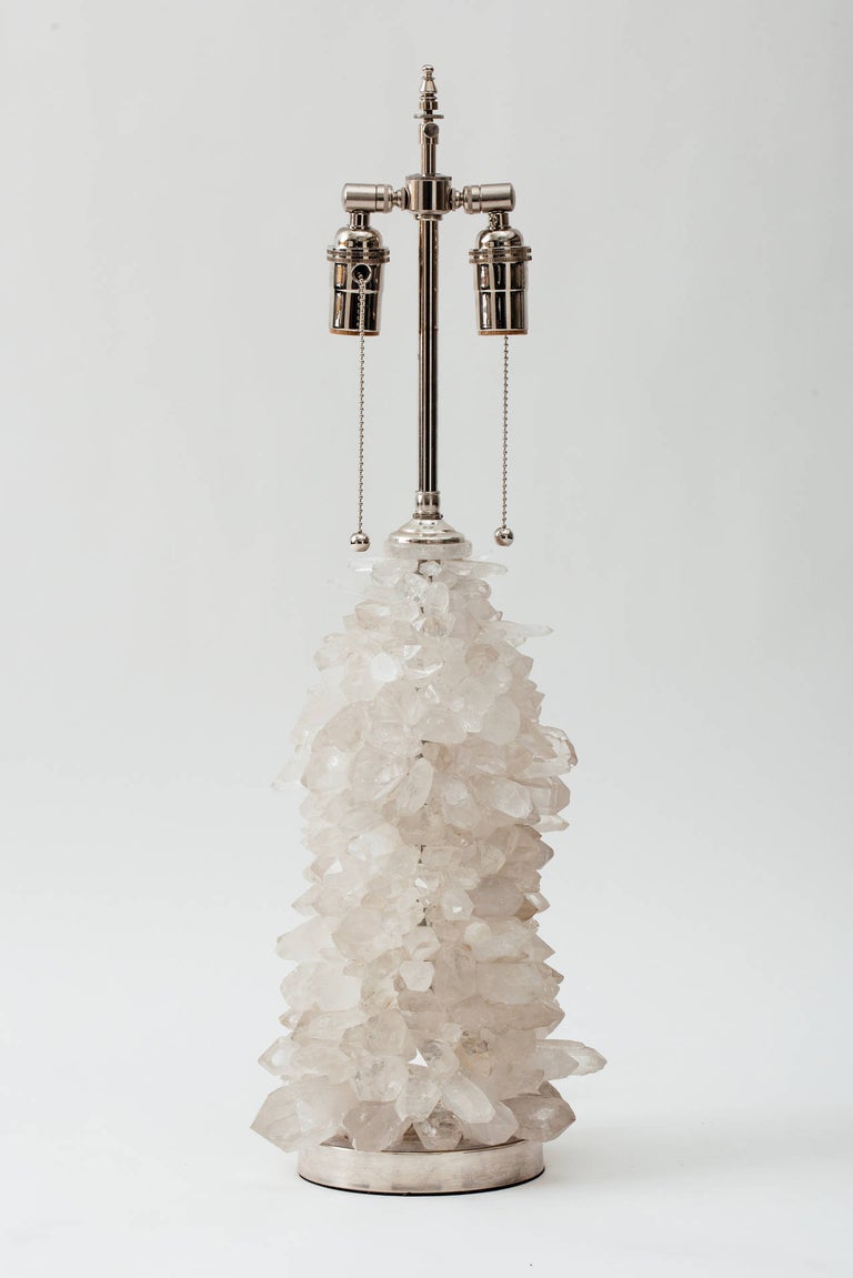 Pair of handcrafted rock crystal cluster lamps with nickel-plated solid brass bases and hardware. 
Lamp body height 15 inches. Overall height 29 inches.
 Double socketed with pull chain switches. 100 max wattage per socket. 
May be custom ordered