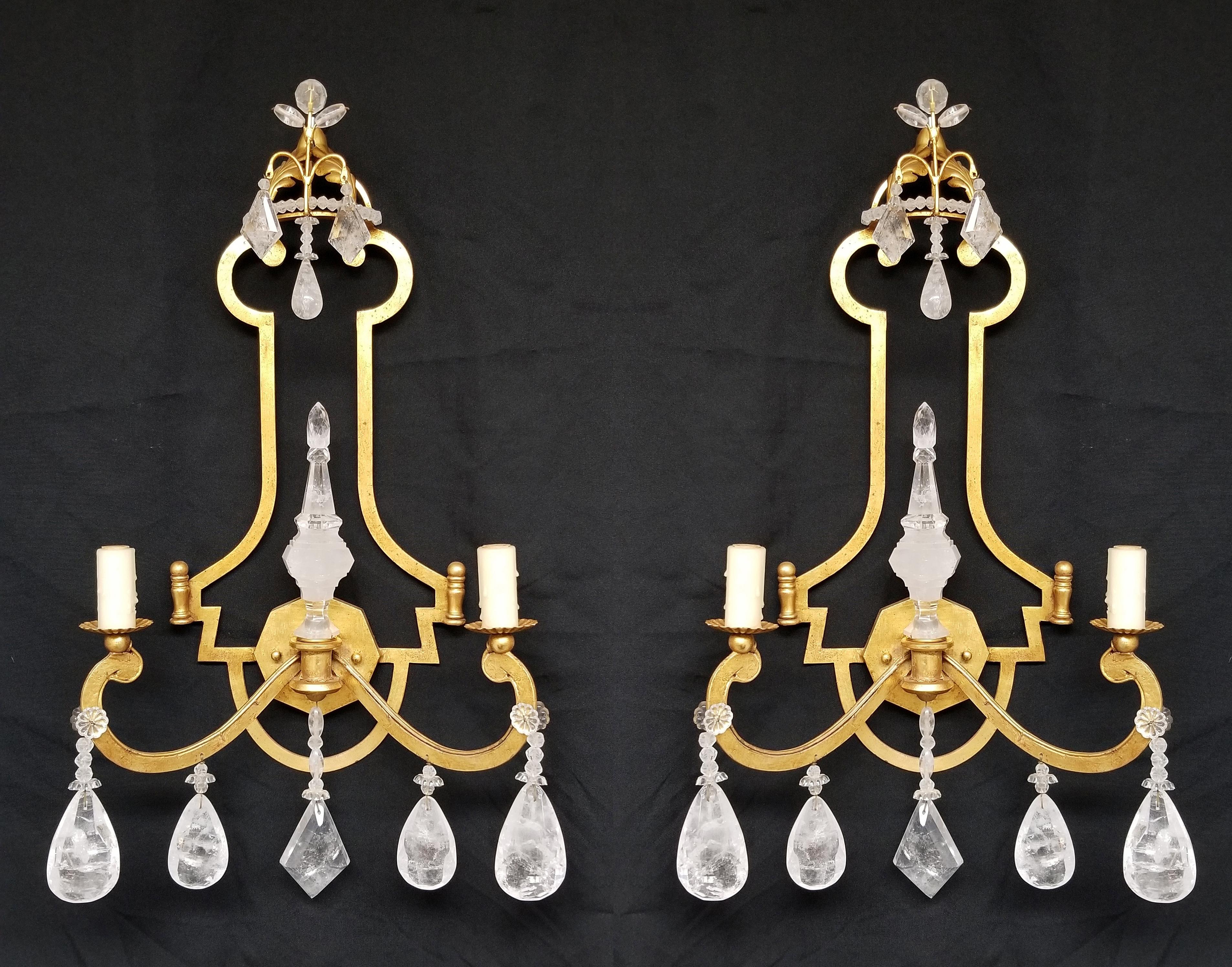 Elegant pair of 22k gold plated hand forged wrought iron two light sconces, with carved rock crystal spike in the center.
combined with 4 hand made bees was candle sleeves. 
Electrified for the American market. 
They come in two sizes:
H. 26