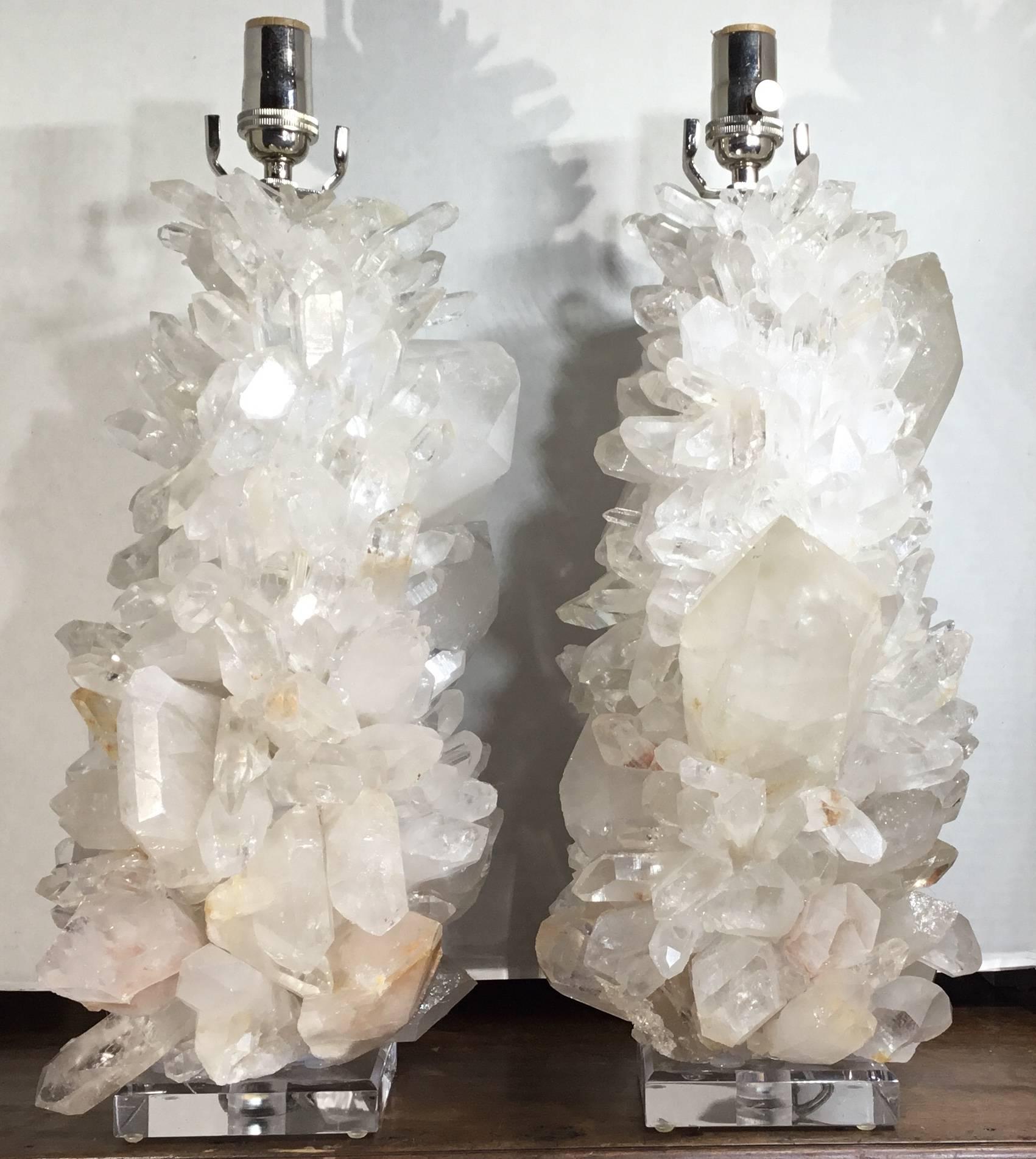 Fantastic pair of lamps made of rock crystal , artistically hand crafted together various pieces of rock crystal to make One Of A Kind beautiful work art to display .beveled Lucite base , Newly electrified and ready to light .  Hight with shades 28”