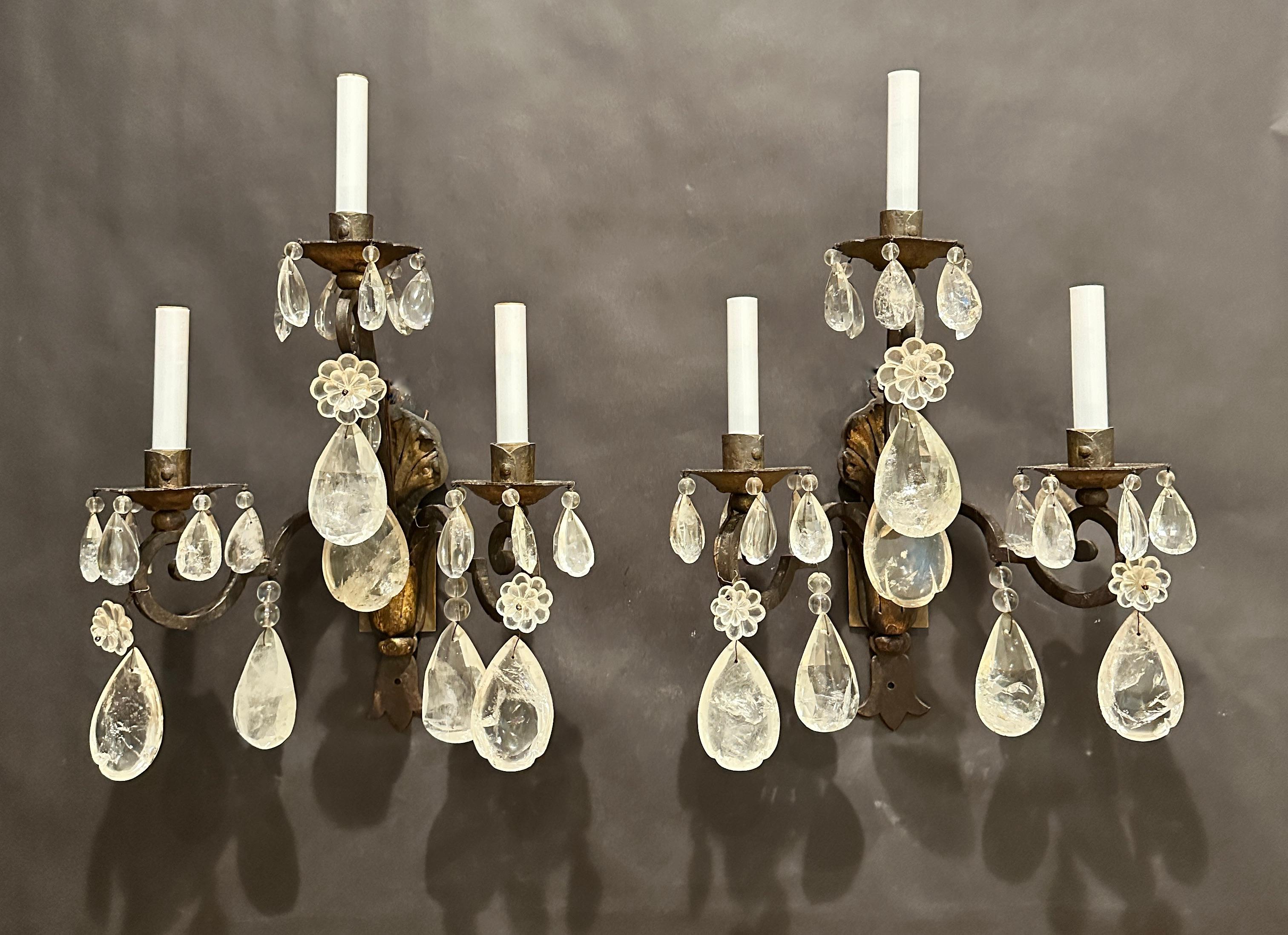 Pair of Gothic/Renaissance form wrought iron and gilt tole frame wall sconces dressed with rock crystal pendants. Rock crystal pendants/prism drops with facet cut and partial cut half pear. 