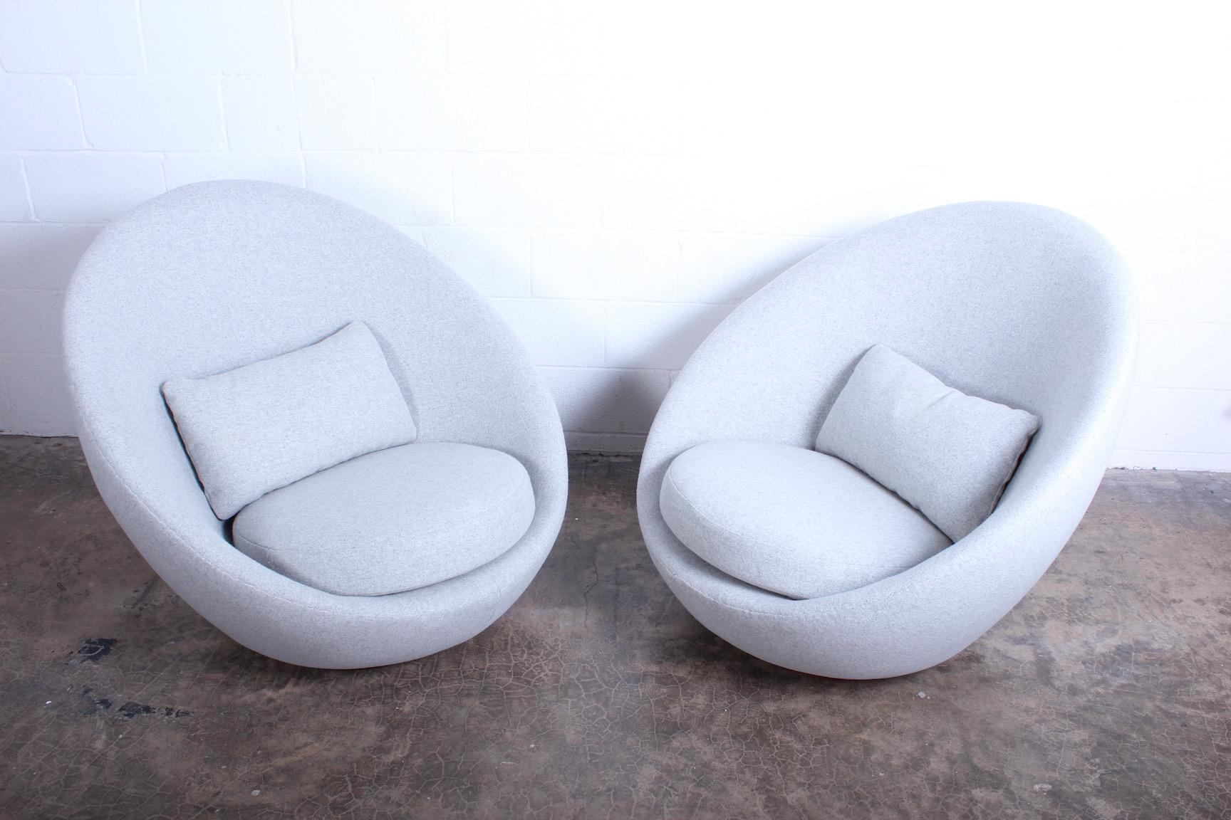 A pair of large-scale rocking swivel egg chairs by Milo Baughman for Thayer Coggin. Fully restored and upholstered in Maharam wool.