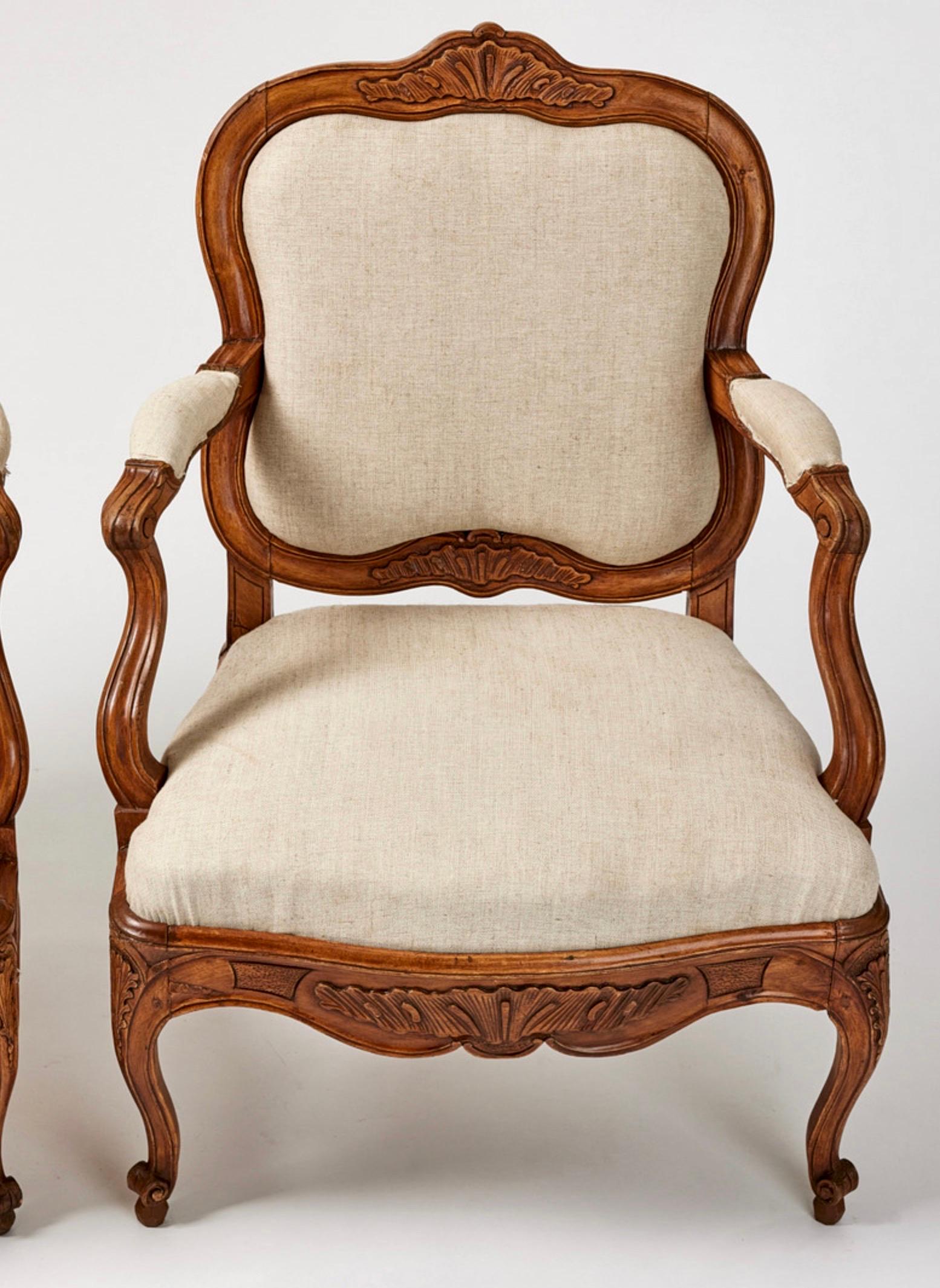 A pair of Swedish rococo armchairs made around 1760 in Stockholm. They are of a large and comfortable size. The carvings are of good quality with typical rococo shapes. The condition is top of the line.