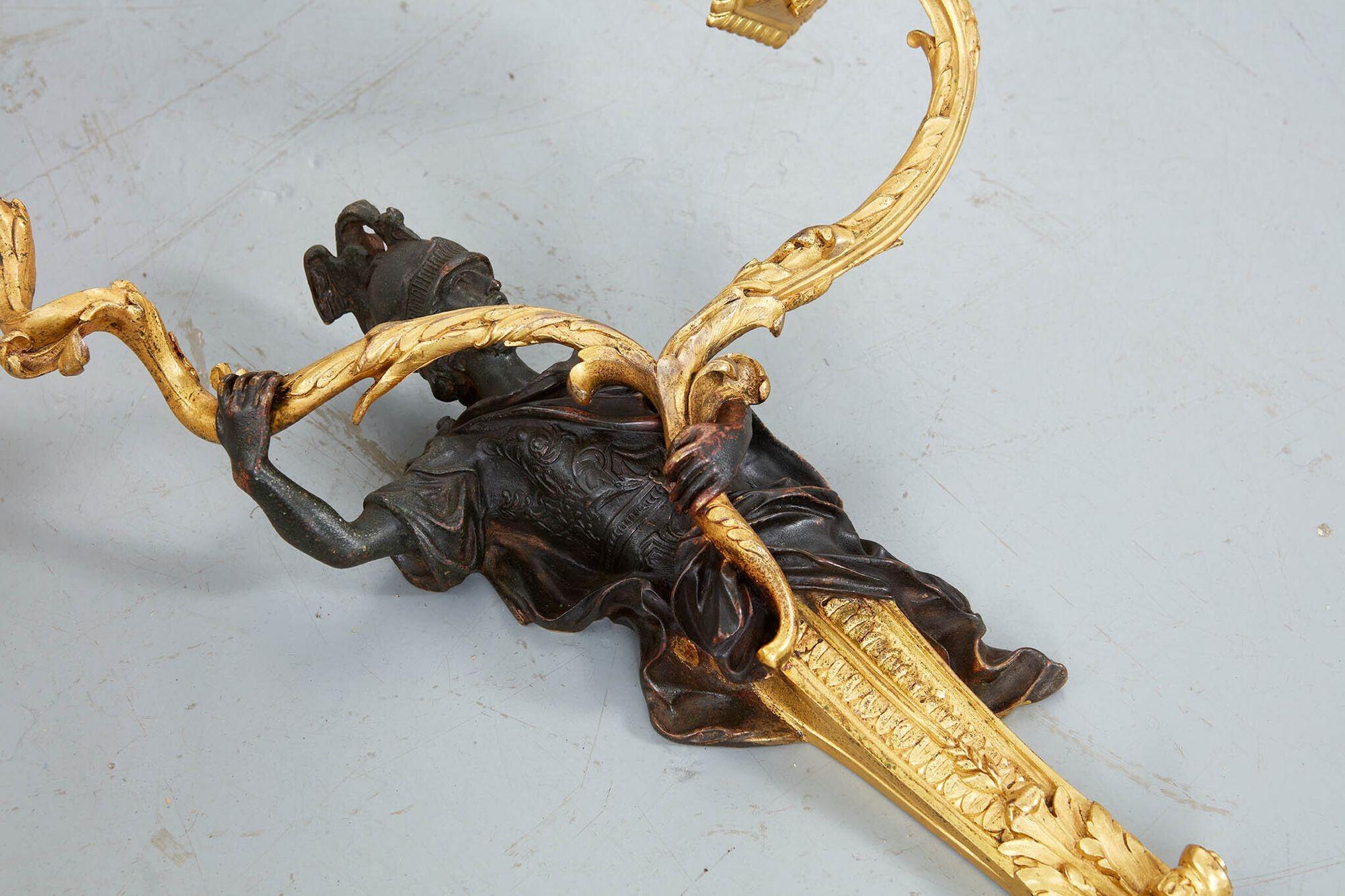 Very fine pair of gilt and patinated bronze two light sconces depicting Mars holding two branches, in the manner of Jacques Caffieri.
Jacques Caffieri was one of France's most important bronze casters during the reign of Louis XV. A nephew of