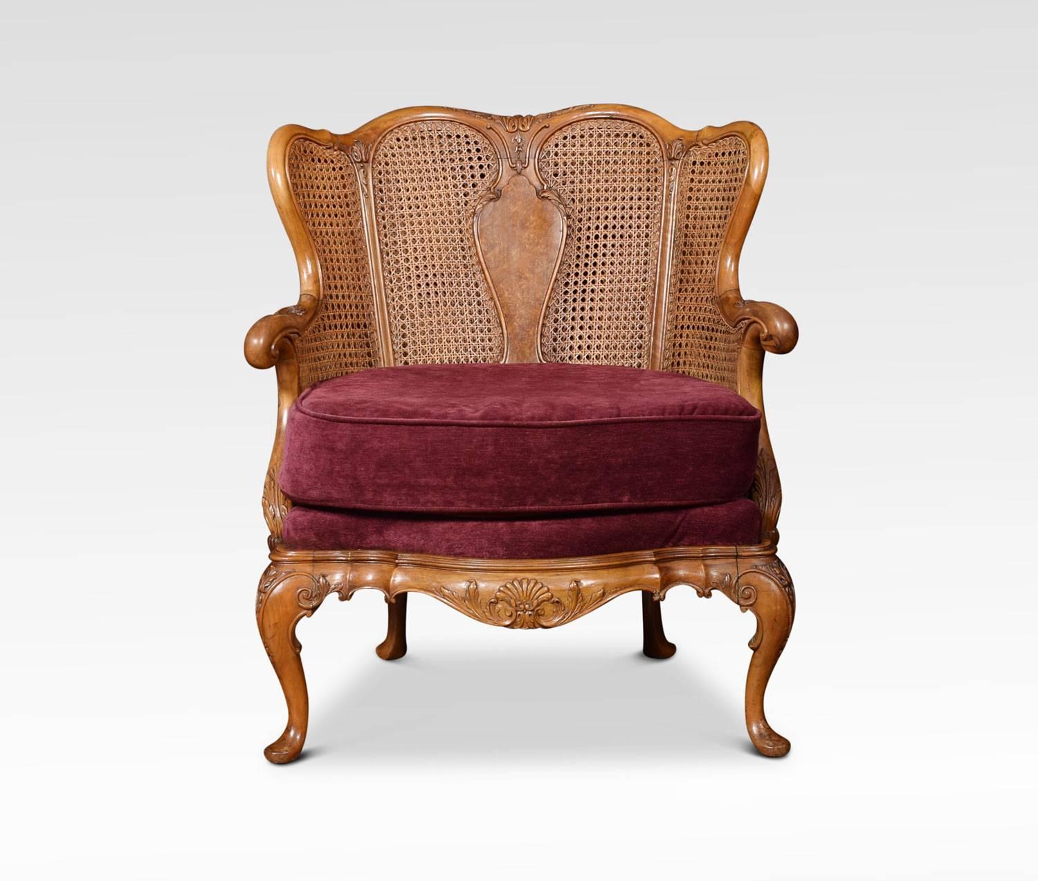 Pair of Rococo design walnut bergere armchairs, the shaped top rail above moulded vase shaped splats, double caned back and sides, enclosed by out swept arms. The removable back and seat upholstered cushions, raised up on carved cabriole