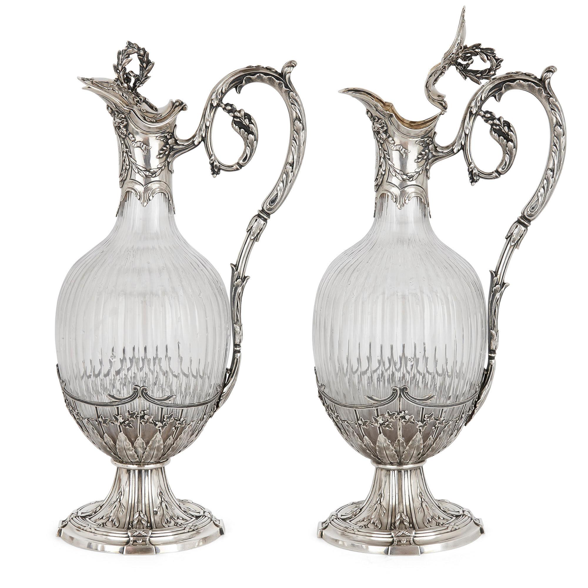 Pair of Rococo style silver mounted crystal jugs by Boivin
French, late 19th century
Measures: Height 31cm, width 15cm, depth 10cm

This beautiful pair of jugs is by Victor Boivin, a leading silversmith working in France in the late 19th