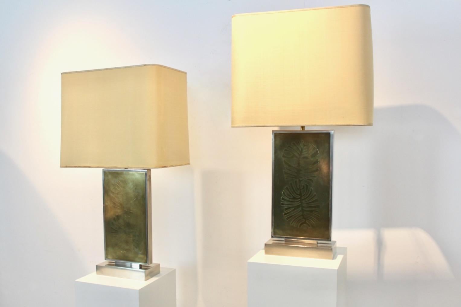 Rare pair of Mid-Century Table Lamps in Hollywood regency style from the ‘70s. These Huge and impressive collectable table lamps were made and signed by the Belgium artist Roger Vanhevel. They are adjustable in height and have the original shades.