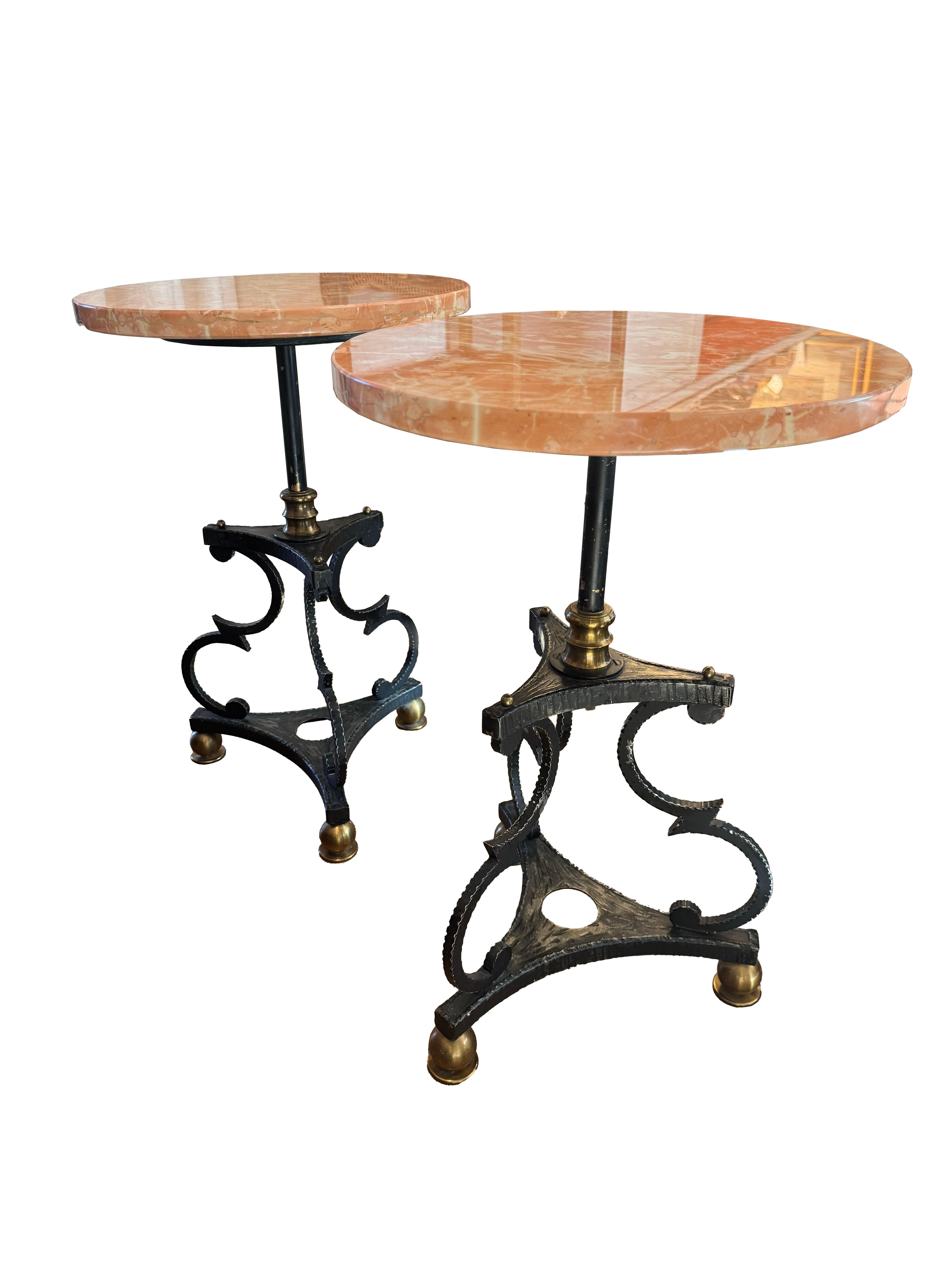 An alluring pair of drink tables, each crowned with a captivating Rojo Marble top, renowned for its striking blend of rich, fiery hues that add an instant touch of sophistication to any setting. These tables seamlessly combine the timeless beauty of