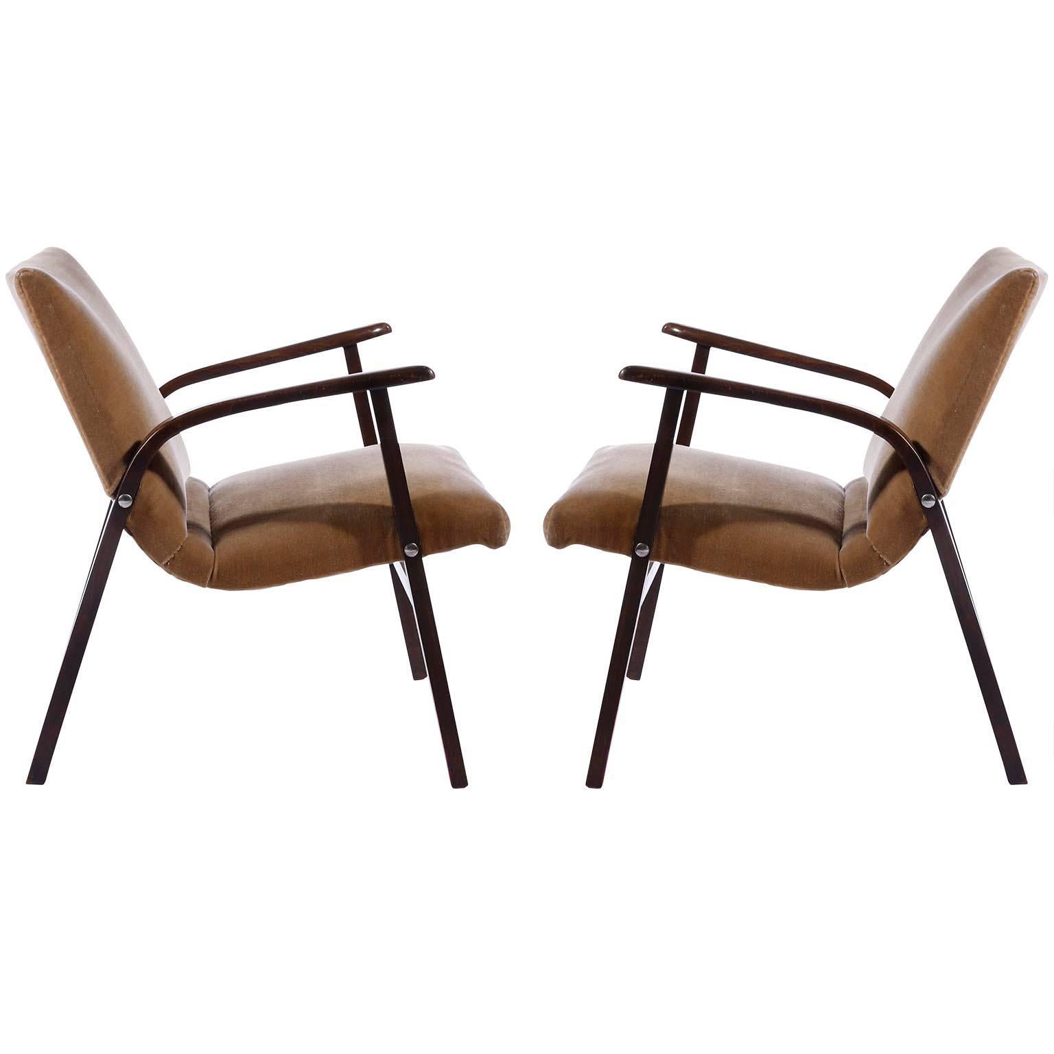 A pair of midcentury lounge chairs designed by Roland Rainer for the Cafe Ritter in Vienna, Austria, in 1952 and manufactured by Emil & Alfred Pollak.
The chairs are in very good condition. Most likely they were reupholstered with high quality